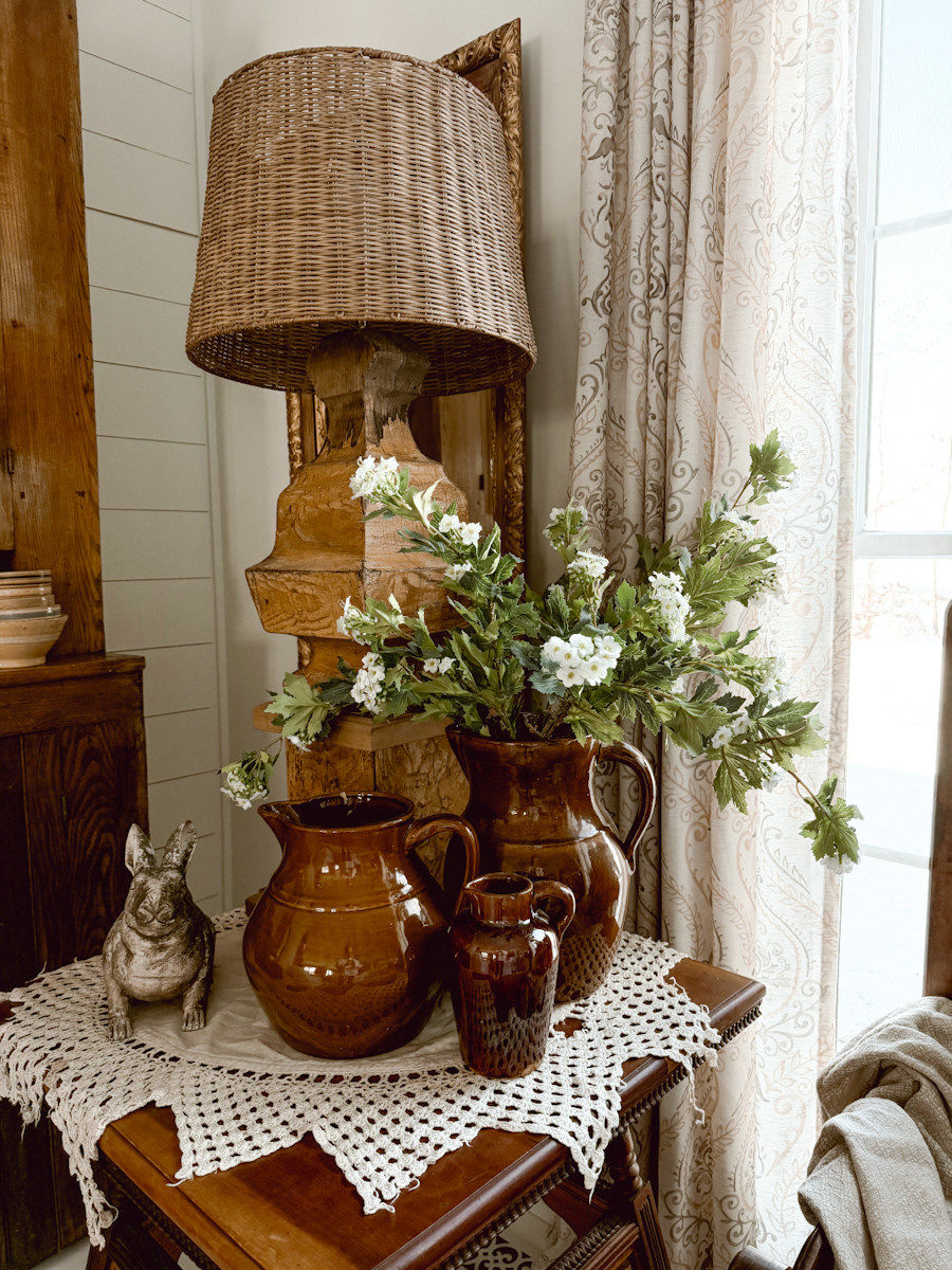 This is is how I styled this antique side table in the corner of our room. I always add rabbit figurines in the springtime as well as a bunch of faux florals.  

 #LTKHome