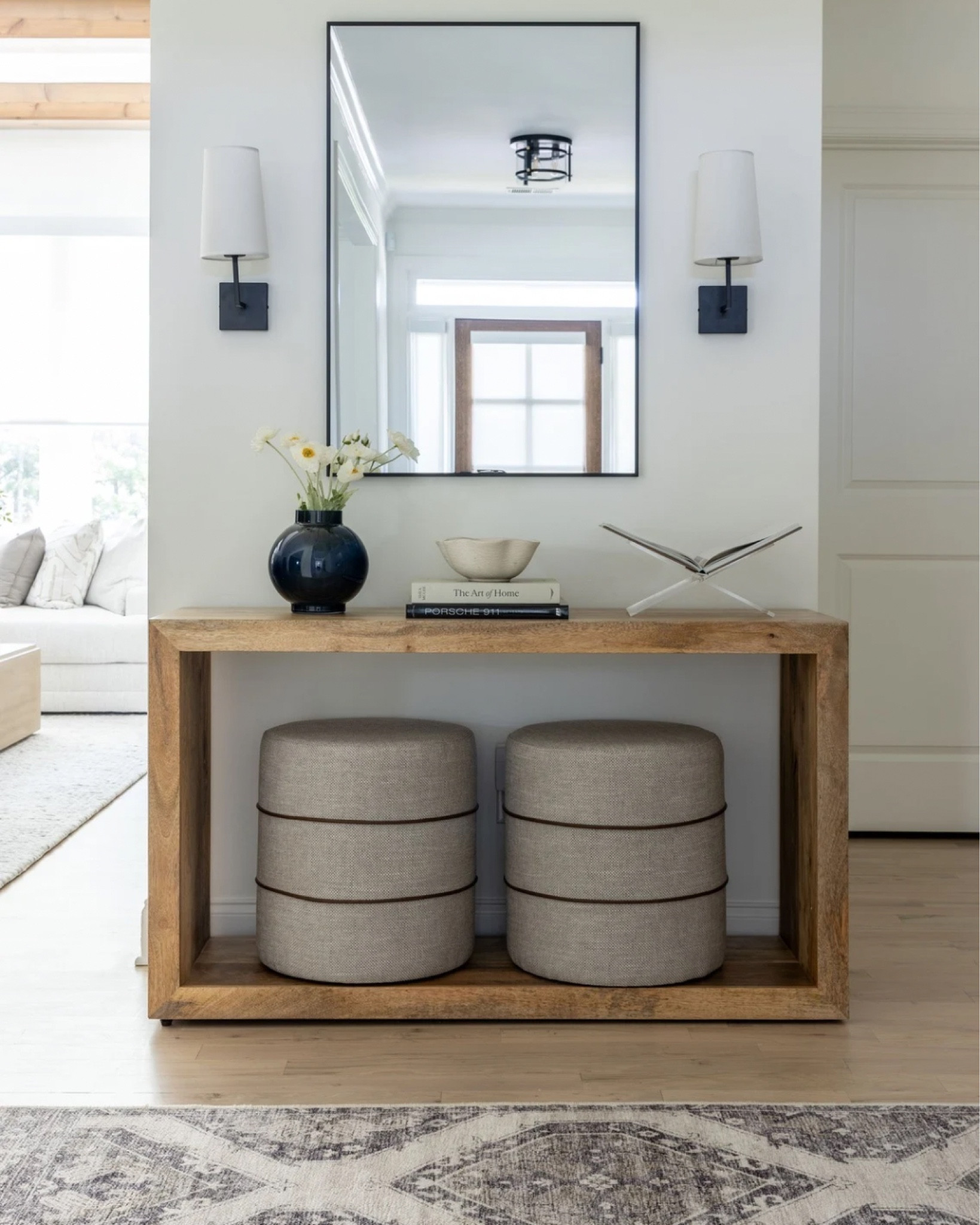 Creating the perfect balance of functionality and style with this inviting entryway setup. The sleek sconces, minimalist mirror, and cozy ottomans all come together to welcome you home with warmth and sophistication. 
 

#LTKHome #LTKStyleTip
