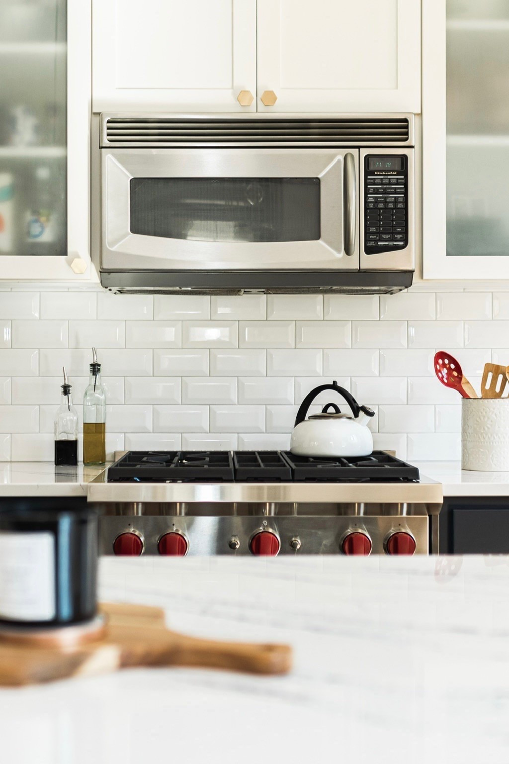 Stylish and simple kitchen countertop decor. As an interior designer, my staples include a white crock for kitchen utensils, stylish cutting boards, glass olive oil dispensers, and a marble spoon rest! Get the look from our #xerxesave project.

#LTKFindsUnder100 #LTKFindsUnder50 #LTKHome