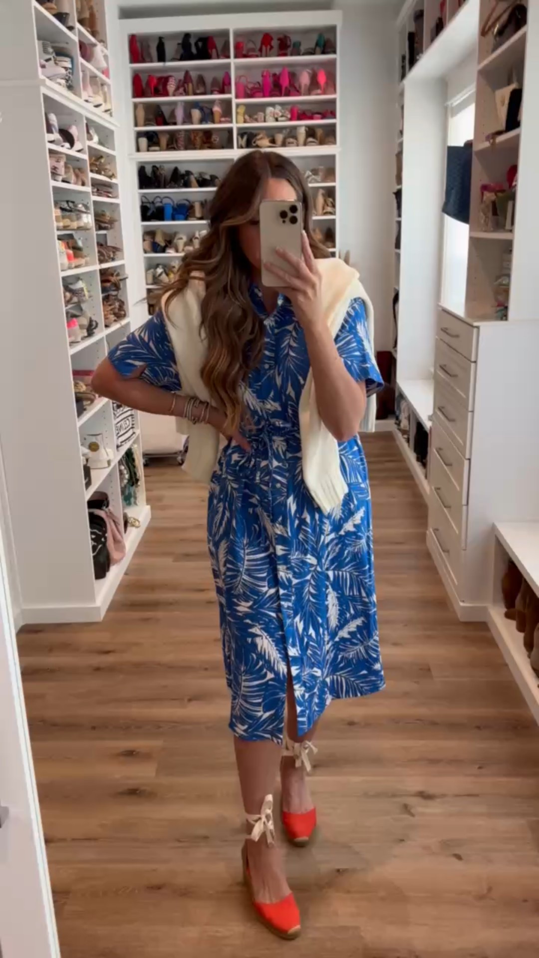 In a medium blue and white palm print tie waist shirt midi dress, tie up espadrille wedges, large American flag sweater and accessories for patriotic look- fits tts.

#LTKStyleTip #LTKSeasonal #LTKFindsUnder50