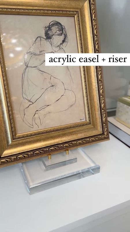 Instead of spending $300 on a lucite picture stand I decided to make my own using a large lucite riser & small  easel I already had 💁‍♀️ Love how versatile these risers are!! 🙌🏻

Found the easel on sale for $16 (friends & family sale discount applied at checkout)!

Decor hacks, home hacks, DIY, sketch art, glam, transitional, modern, aesthetic, gold framed sketch art, sideboard styling office decor 

#LTKunder50 #LTKstyletip #LTKhome