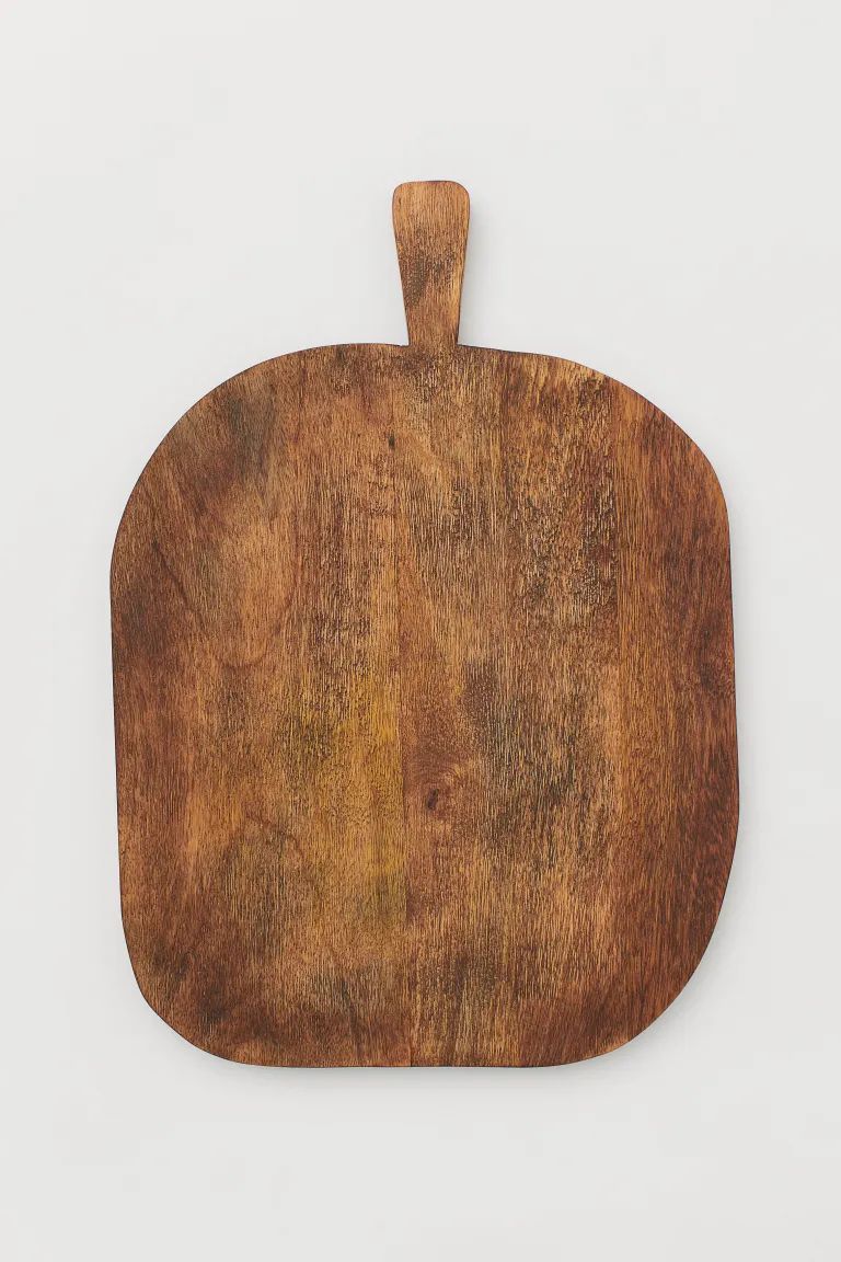 Mango wood cutting board shaped like a classic bread paddle. Small handle at top. Width 11 3/4 in... | H&M (US + CA)