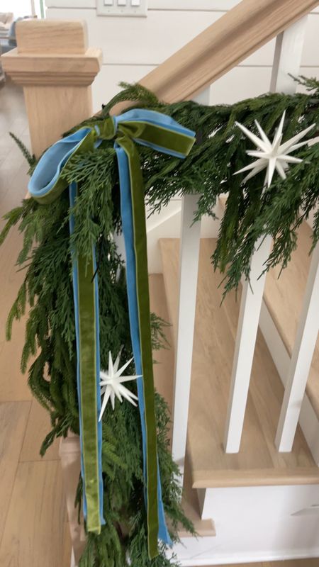 In progress garland on our staircase this year! Loving the real touch Norfolk pine garland layered with this faux cypress garland. The white starburst ornaments are a fun touch paired with the blue and green velvet ribbon! Also linking our blue console table in our entryway.
.
#ltkhome #ltkholiday #ltksalealert #ltkfindsunder50 #ltkfindsunder100 #ltkover40 #ltkstyletip #ltkseasonal #ltkvideo

#LTKsalealert #LTKHoliday #LTKhome