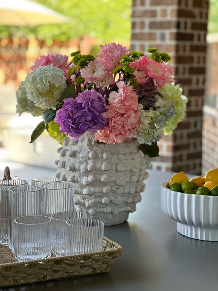 The famous minka pot!! It’s gorgeous anywhere in your home with faux or reel flowers!! I have it out year round! Alonso shown is my Walmart fluted bowl and fluted glasses for outdoor use!! And of course this woven tray!! 

#LTKFind #LTKSeasonal #LTKhome