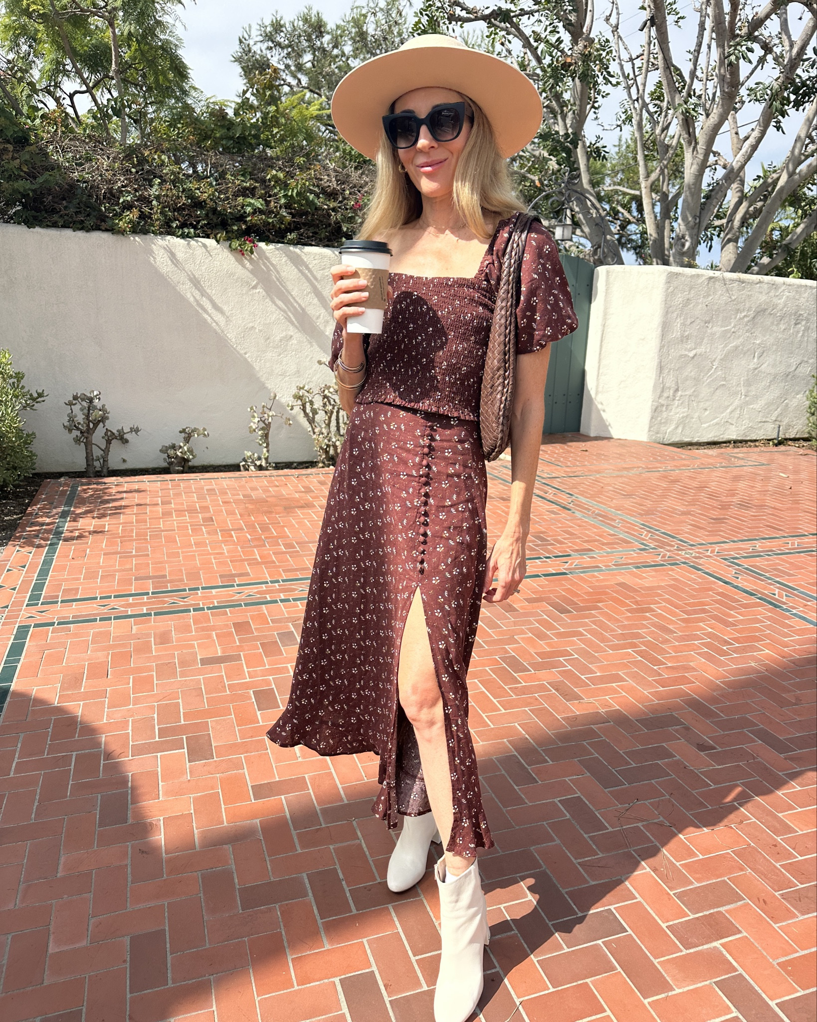 When it’s still warm but you want fall vibes, swap sandals for boots. A flowy skirt or dress + ankle or mid-calf boots instantly transition your wardrobe without overheating. Add a wide brim hat for that effortless chic finish. 🍂☕️ I’m in love with this floral midi skirt + matching top and the boots are on sale! Shop my look & follow me for more simple style tips & main character outfits! 

#LTKStyleTip #LTKOver40 #LTKShoeCrush