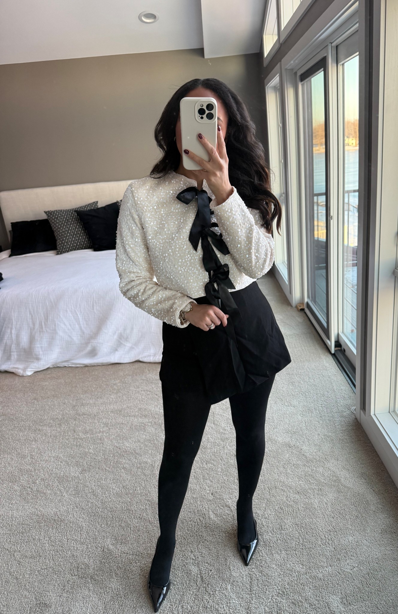 Girls Night Out Holiday Edition! 🎄✨ For dinner and a show I’m styling this white sequin top with black bows in the front, black skort, fleece lined tights, and black kitten heels that are 35% off with my code: SARAHJUDE35! 

#LTKootd #LTKHoliday