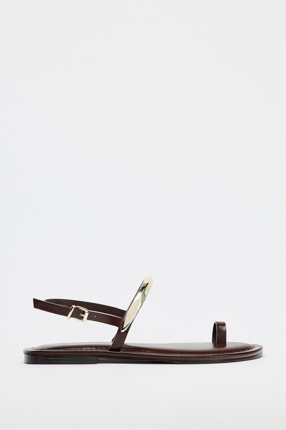 Flat slide sandals. Toe loop. Strap with metal detail on the upper. Ankle strap with buckle closu... | Zara US