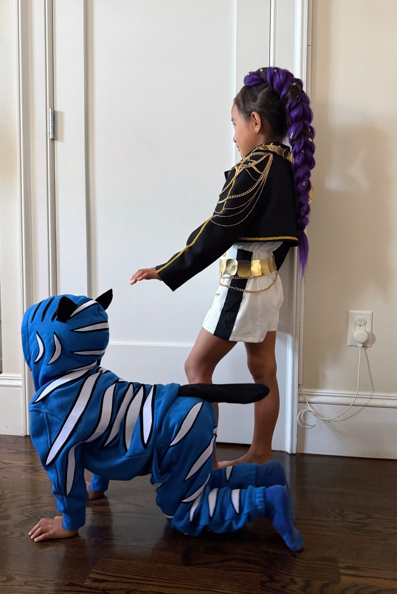 Kpop demon hunters Halloween Costume DIy links for those asking:

• Derpy tiger used a blue sweatsuit and peel and stick velvet, great for temporary last minute costumes. Comes in sheets or rolls if you need longer length.

It can be removed so you can wear the clothes normally after Halloween. Tail is a black sock stuffed and safety pinned.

• rumi braid: bought and linked 2 brands of hair extensions on Amazon. Each brand linked makes 2 braids per order, so split with a friend or you have extra if you mess up. Both are lightweight, but the shorter 24” is lighter. 

// In the tutorial videos I’m holding up a finished braid using BRDLOCK brand 24” extensions. This brand’s texture was a little softer and fuller to work with. 24” is a little short on my 7 year old for Rumi’s look, but it was comfy to wear all day. One package makes 2 braids.

// In the same videos my kid is wearing ZAVIDE brand 30” long extensions. This brand’s bundles are smaller, so a “4 pack” actually = 2 pack in other brands. I combined 2 together to make 1 braid, so the entire package also makes 2 braids. This one was a nice purple color.

// black jacket is thrifted zara 

// white shorts are current Zara sz 6/7 . they are slim fit. I found some wide black ribbon and added to each side 

// white top is nice & soft. I sized down 

// used faux soft gold leather and glue gun for the shoulder patches , the strap on the right side, and the belt is rounded pieces I cut out and hot glued onto a long strip. 

// Also used the gold edge trim and Missgrace brand chain harness linked with 3 detachable pieces - part of the chain is on the jacket, and part of it is on the shorts.

DIY Halloween costume idea for girls, kpop demon hunters, Rumi hair braid tutorial 

#LTKKids #LTKFamily #LTKHalloween