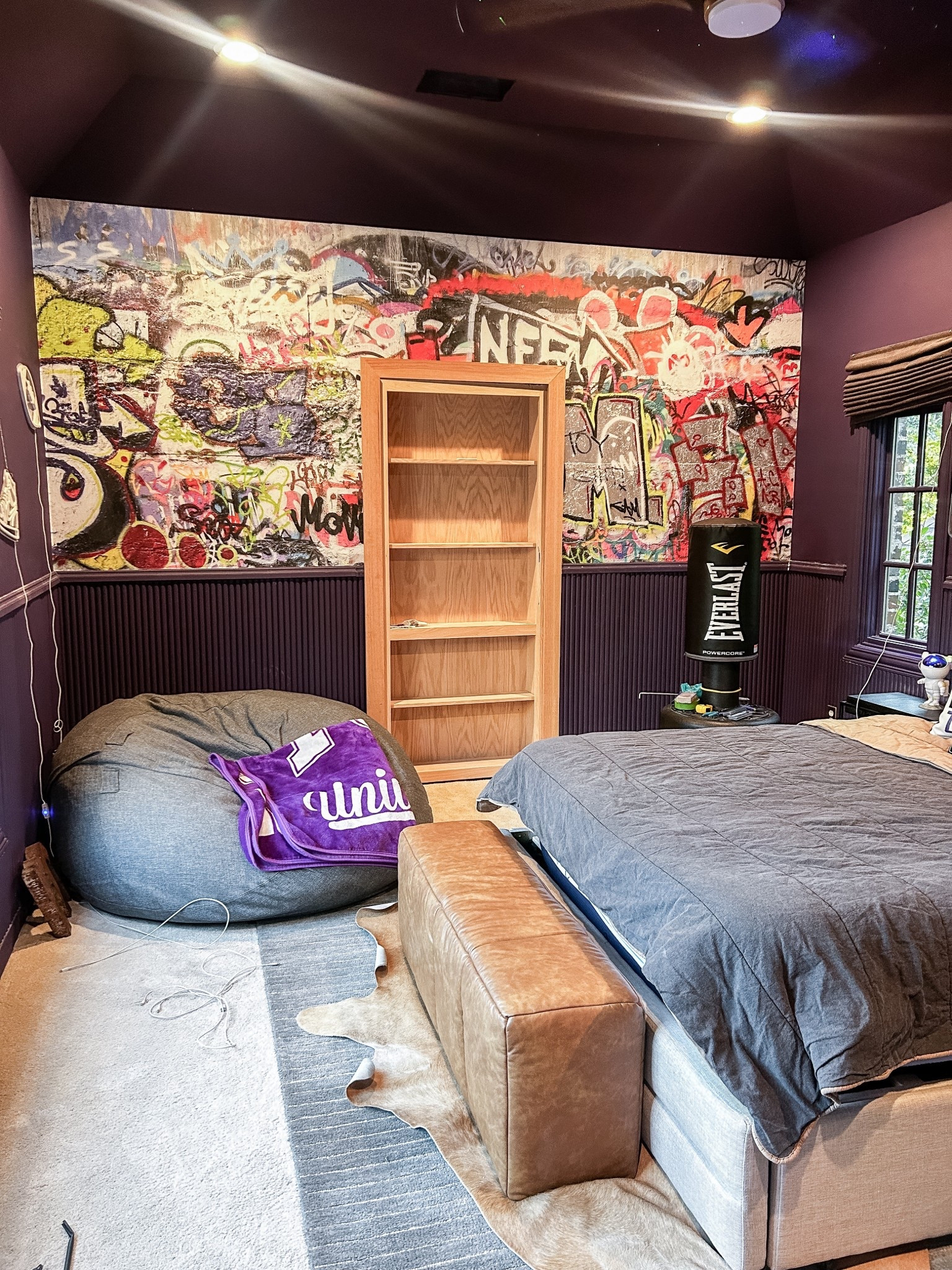 Teenage boys bedroom makeover progress! Installing the hidden bookcase door. Mural is from Limitless Walls 

#LTKKids #LTKHome