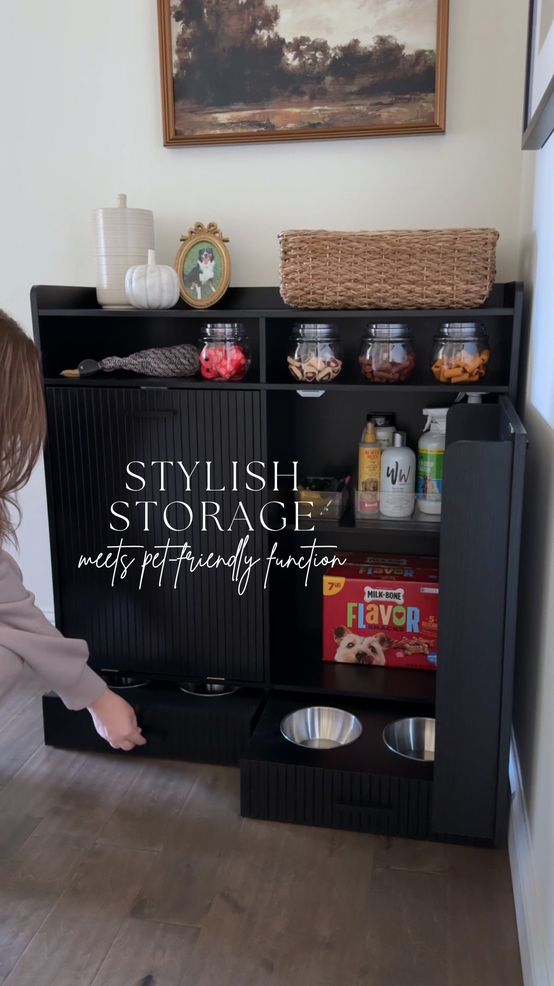 Stylish storage meets pet-friendly function 🐾 This sleek black cabinet features hidden storage for dog food, treats, toys, and grooming essentials, hooks for leashes and collars, and a built-in feeding station with pull-out bowls. It’s also a great option for kitchen storage, with room for a trash can and pantry essentials. Love the fluted details and versatile design!