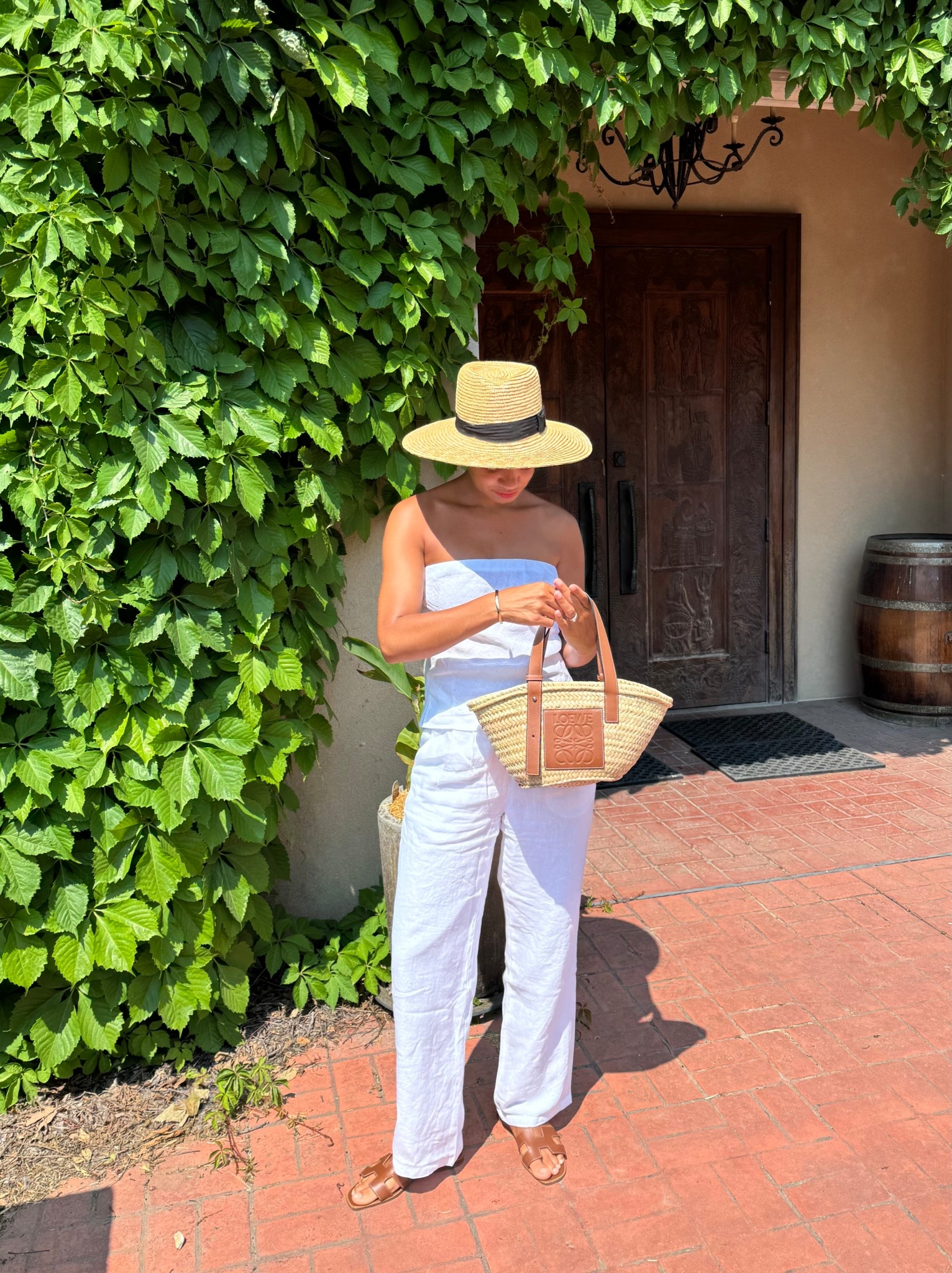 Summer linen outfit idea: white strapless top paired with white linen pants, sandals, a straw bag, and a straw hat 

#LTKStyleTip #LTKSummerEdit #LTKSeasonal