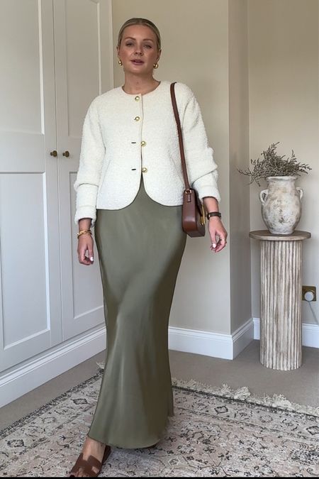 Khaki green satin skirt styled with a cream cardigan and brown accessories 
