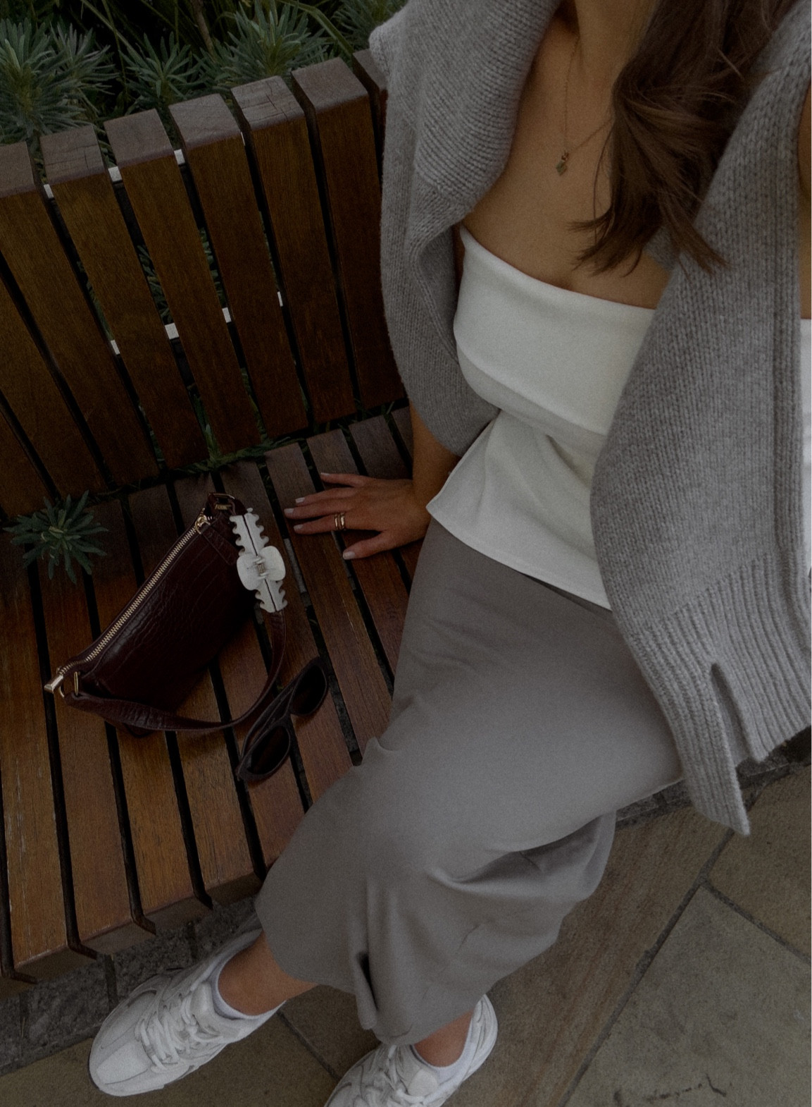 Grey skirt outfit
White bandeau top
White knit sweater
New balance 530s

#LTKSeasonal