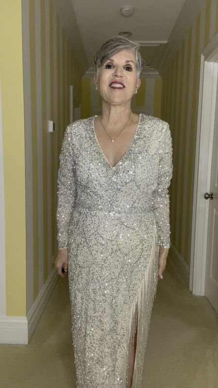 Beautiful black-tie dress for the mother of the groom or any formal event. Pretty v-neck silver beaded dress by MacDuggal. Pretty side slit. Size 10 and is a bit big. I’m 5’4”. Styled with a pave heart necklace and diamond stud earrings.
Please subscribe to my free newsletter for more tips @https://drjuliesfunlife.com/
#ltkover40
#ltkover50

#LTKSeasonal #LTKwedding #LTKstyletip