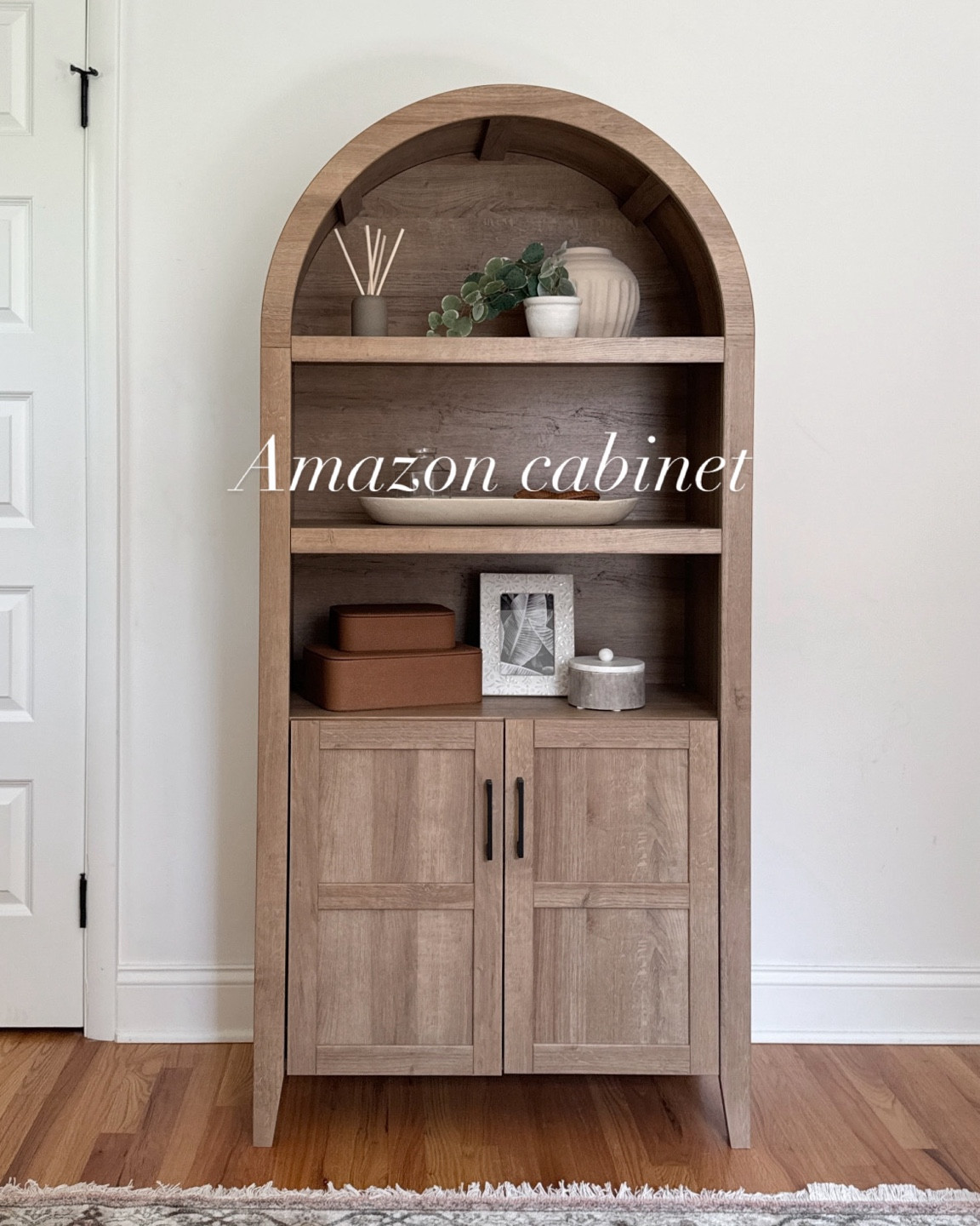 New arched cabinet from Amazon🤍 One of the least expensive arched cabinets I have seen on the market, but you wouldn’t know it from looking at it!! I have the white oak color, but it also comes in black!

My home office has been a labor of love for the past 3+ year of living in this house. I am someone who is always changing up my decor and I love to experiment with different style. This is definitely my favorite office style yet, and I will not be changing it any time soon! I love the neutral colors I am bringing in. I love sitting in here to work + hobby now!

Office inspiration, amazon furniture, amazon find, amazon home find, amazon home decor, arched cabinet find, affordable amazon find, affordable home decor

#LTKHome