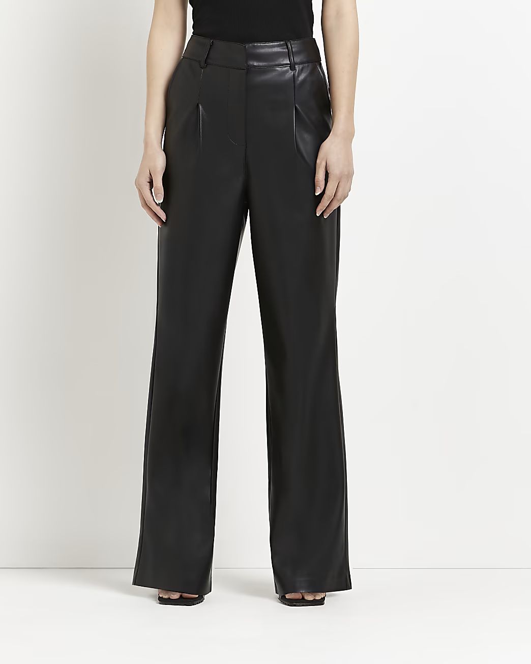 Black faux leather wide leg pleated trousers | River Island (UK & IE)