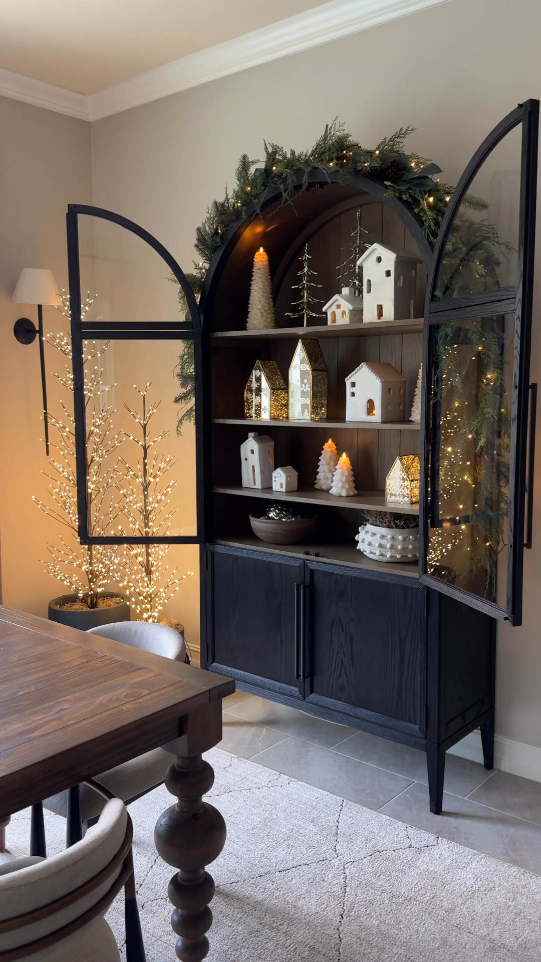 Ever since I was a little girl, I loved setting up a holiday village for display at Christmas. I love styling these little  houses in my arched cabinet for the holidays. I add tea lights and fairy lights to give them a magical glow.

#LTKHome #LTKHoliday #LTKWatchNow