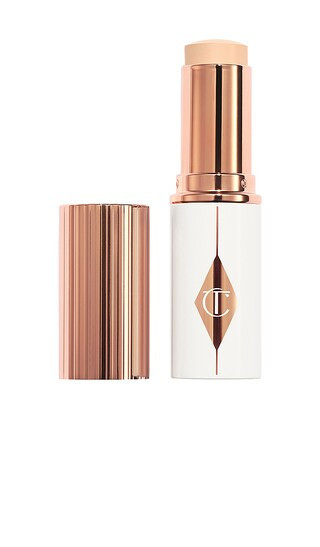 Charlotte Tilbury Unreal Skin Sheer Glow Tint Hydrating Foundation Stick in 1.5 Fair. | Revolve Clothing (Global)