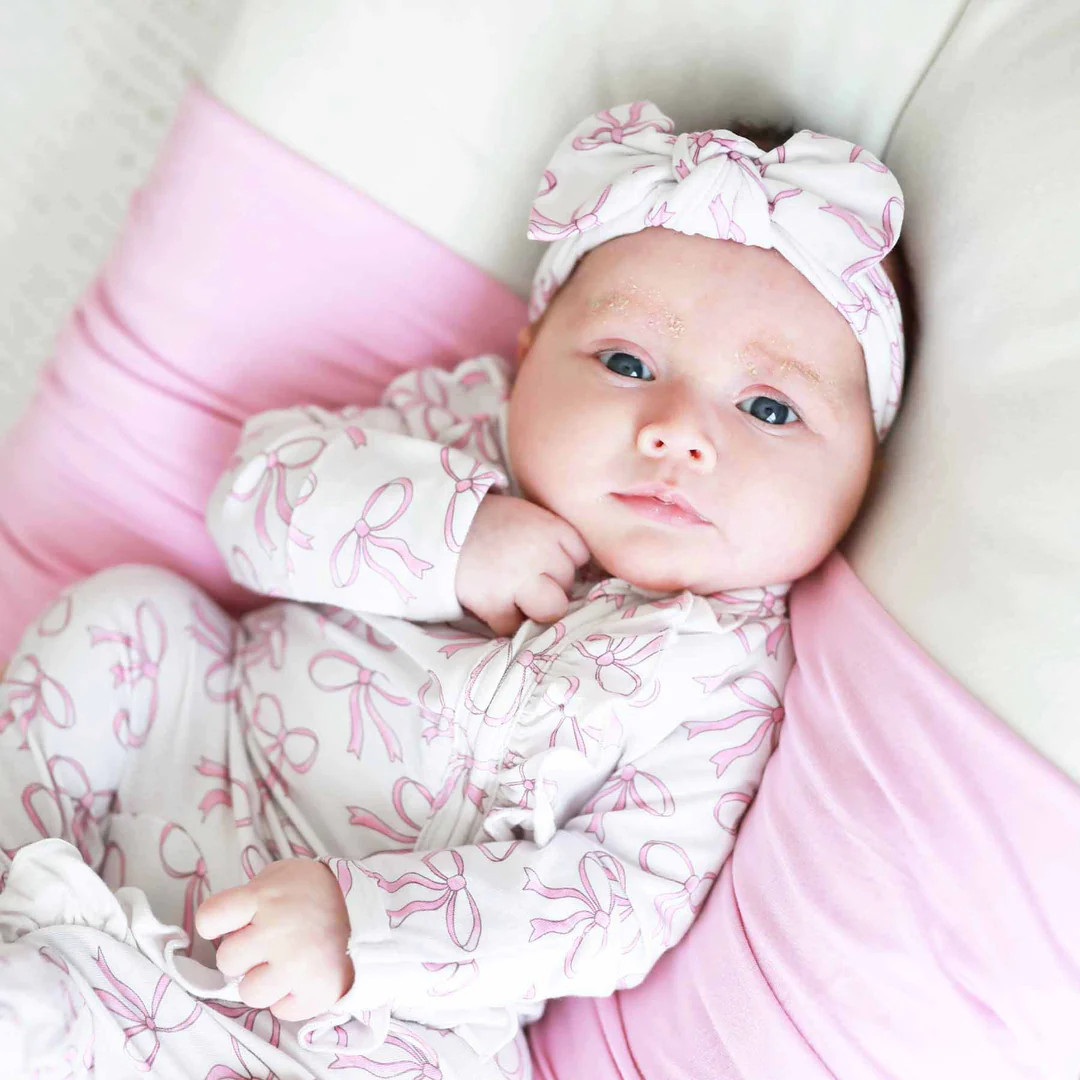 Blushing Bows Ruffle Zipper Footie | Caden Lane