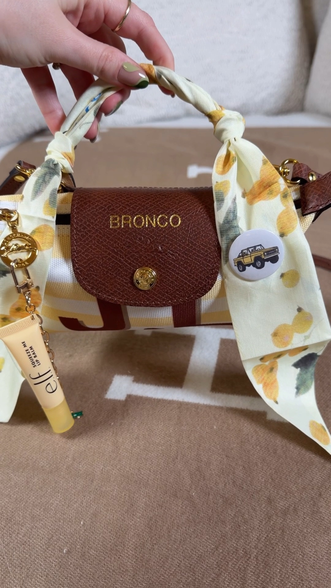 Pack my custom Longchamp Le Pliage pouch for a ride in my yellow Bronco 💛 I picked color combos to match my car and even had to make a little bronco pin to add to the Twilly 💛

Yellow silicone lip gloss phone case
Glossier monochrome gold eyeshadow 
Jo Malone orange blossom

I made my elf lip gloss into a keychain with the kit I linked 💛