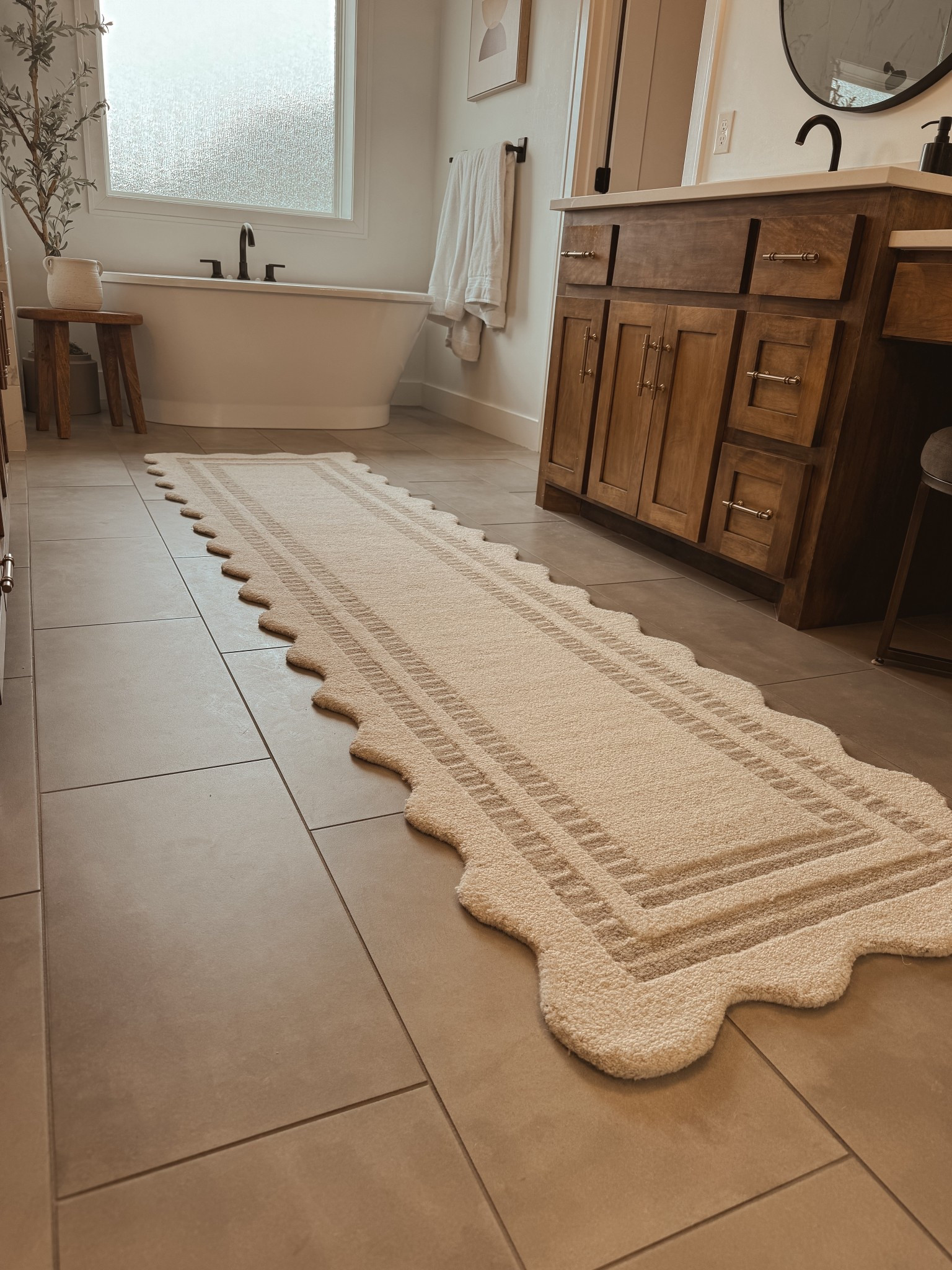 I’m obsessed with mixing cool
And warm tones. Elevated this space by layering this cream scalloped beauty over gray tile 🤩

#LTKhome 
