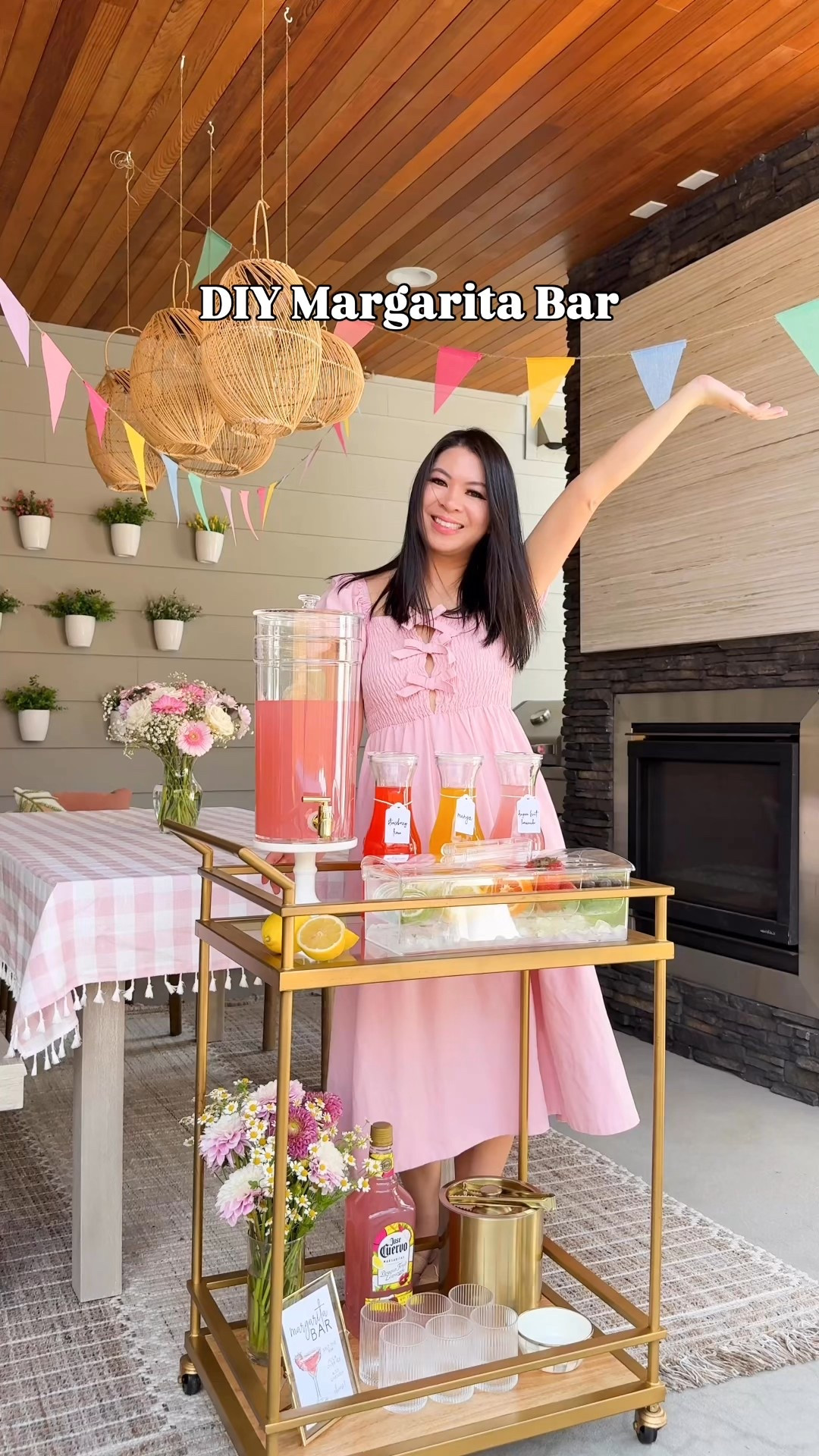 DIY MARGARITA STATION! 
I used @josecuervotequila Authentic Margaritas for this cause you just pour it out over ice, garnish, and it's ready to go! Makes hosting soo easy! Which flavor would you choose - Dragon Fruit Lemonade, Mango, or Strawberry Lime?

Bar cart, glassware, bowl, metal ice bucket, server caddy, glass carafe, pink checkered tablecloth, outdoor furniture, table, chairs, rug, planter, plants, patio furniture, pink bow dress, rainbow flag banner 

#LTKParties #LTKHome
