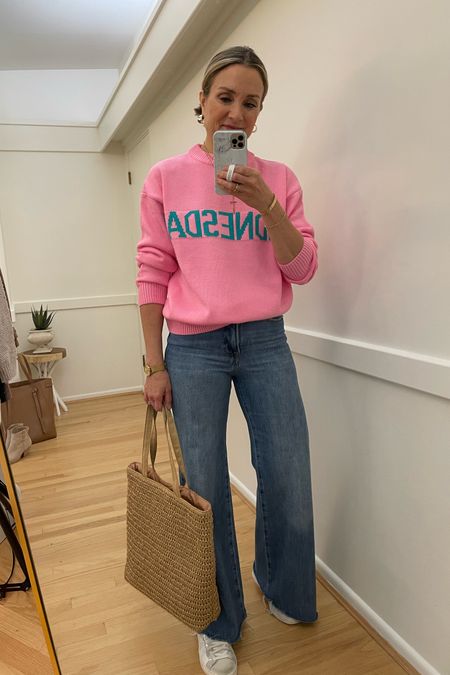 On Wednesdays we wear Pink! Love this fun graphic pink sweater! Wearing a small. Good American palazzo jeans, white sneakers spring outfit straw tote wide leg jeans mirror selfie 

#LTKFind #LTKstyletip #LTKunder100