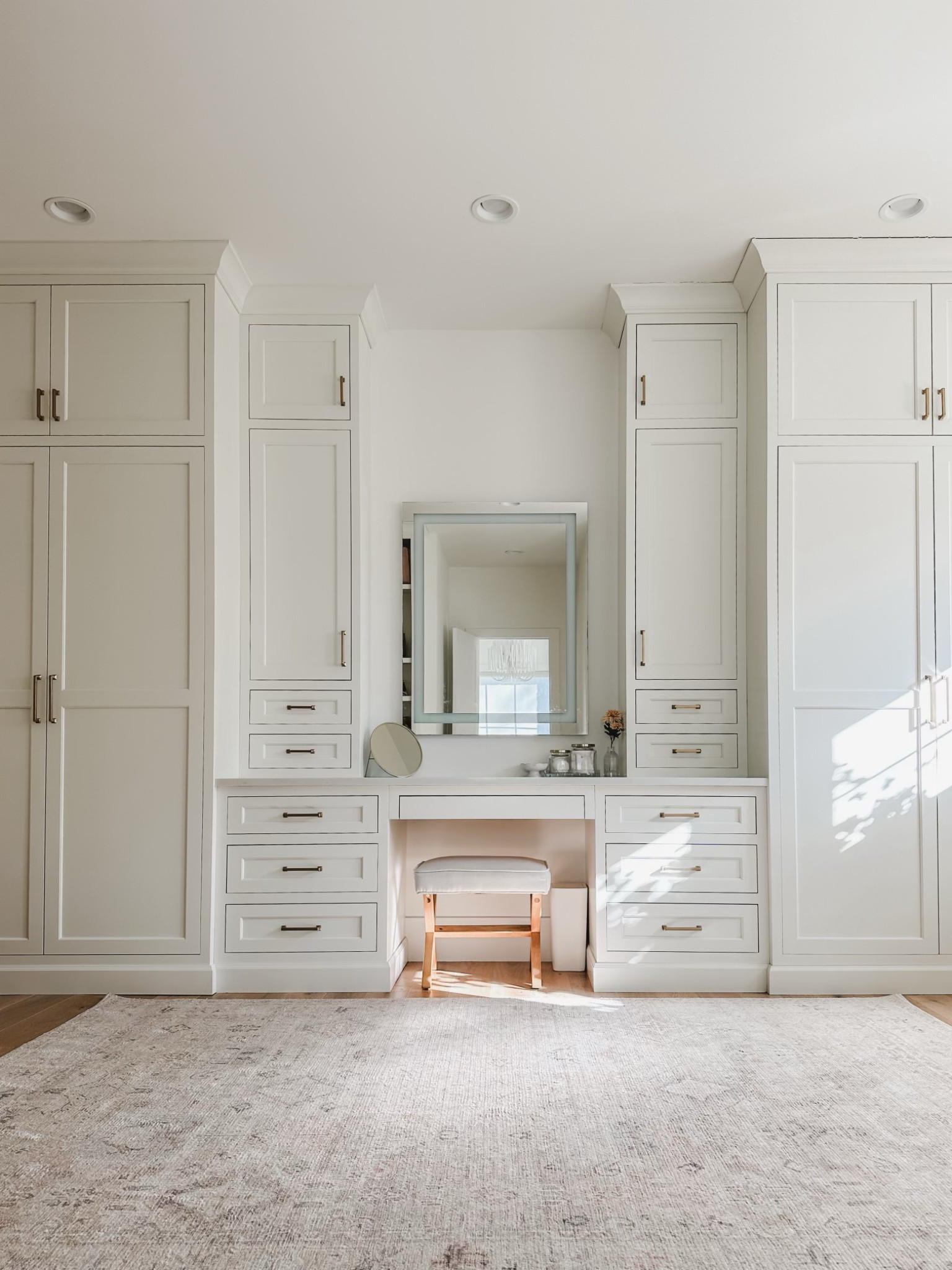Primary bedroom closet with built in vanity details featuring creamy whites, natural wood tones, and gold detail. Loving this vintage inspired Becki Owens rug to warm up the space 

Home organization, spring refresh, home finds, primary bedroom closet, vanity stool, gold detail, creamy whites, warm woods, vintage inspired rug, Becki Owens, vanity mirror, Amazon Prime, found it on Amazon, Target, light and bright, aesthetic closet, organized home, shop the look!

#LTKSeasonal #LTKstyletip #LTKhome