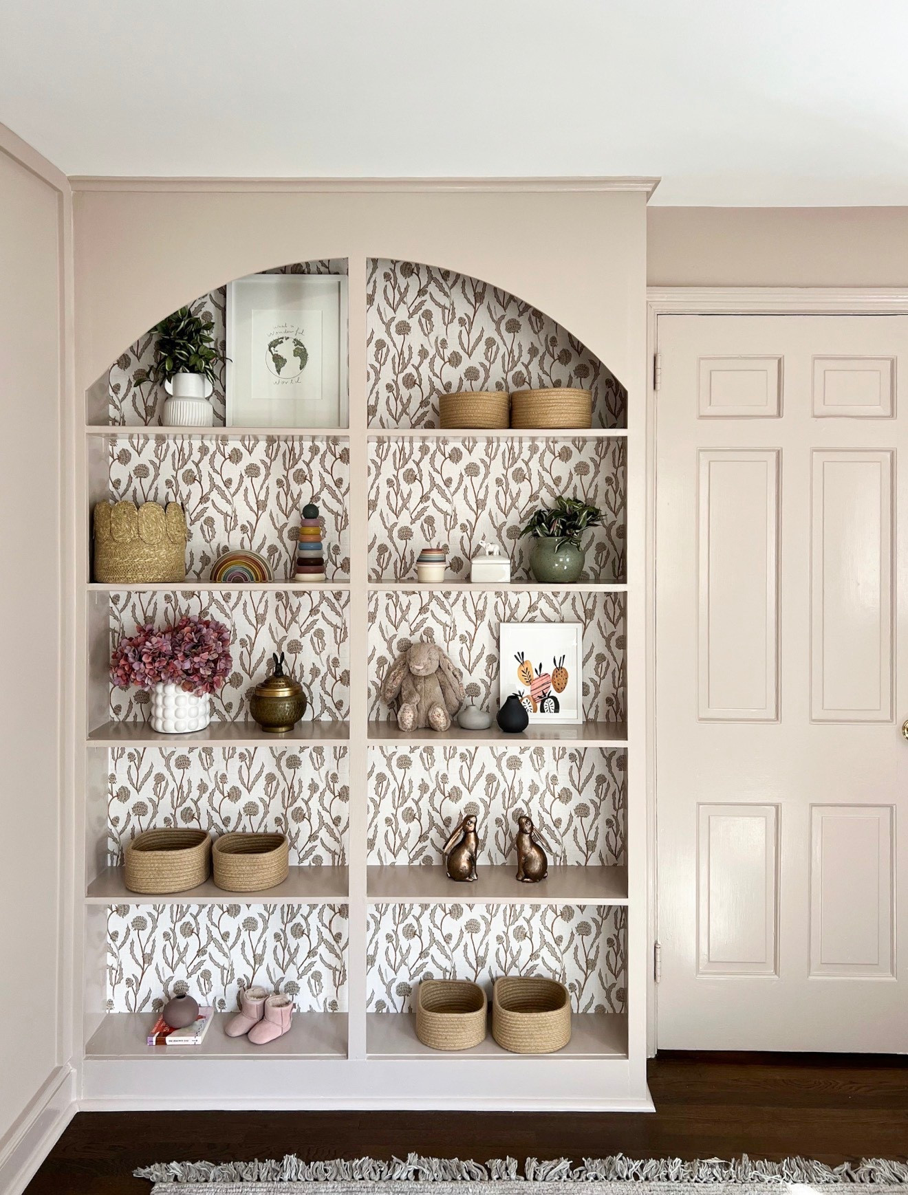 Built-ins like this make the whole room feel so elevated. The wallpaper backing adds just enough pattern while still keeping everything neutral and calm. It’s the perfect mix of functional storage and styled moment

built in shelves, nursery storage, kids room storage, wallpaper backing, neutral nursery, shelf styling, home organization, kids room decor, interior styling

#LTKSeasonal #LTKmomlife #LTKKids