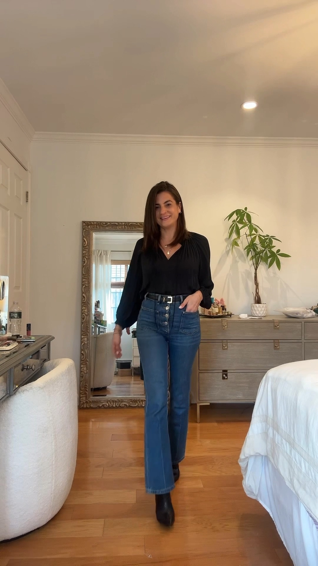 Dark maje jeans and a silky black top for a family reunion party 