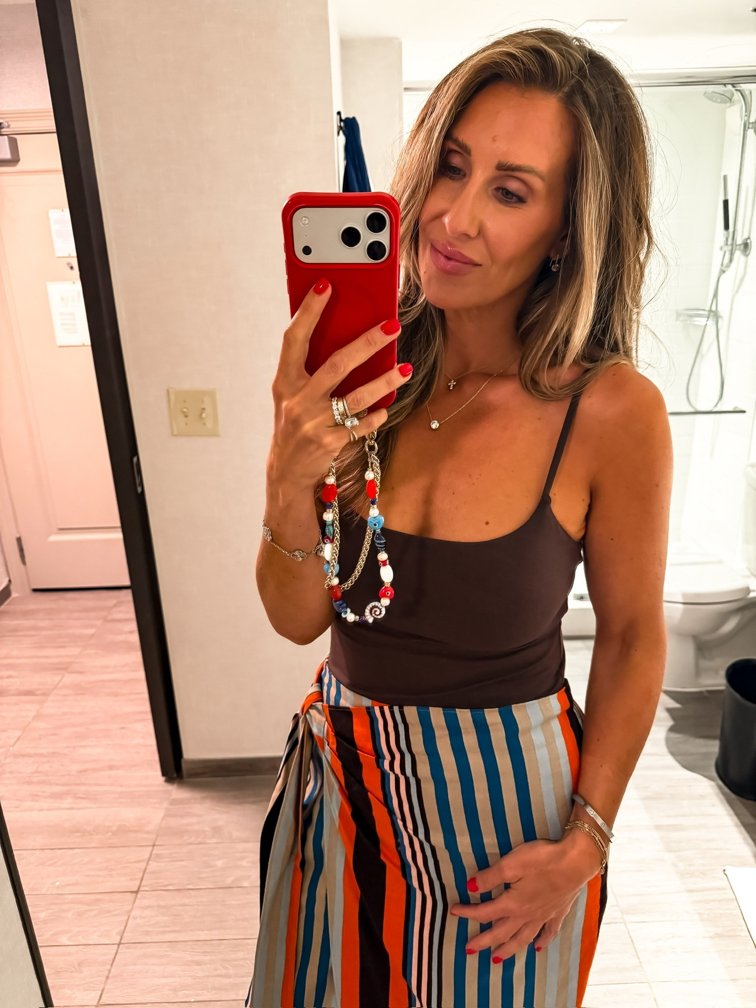 I wore this for dinner and loved how the simple fitted tank balanced the colorful wrap skirt. The smooth stretch fabric sits close without bunching, while the striped skirt ties at the waist and moves beautifully when you walk. The mix of chocolate brown, blue, cream, and orange made the outfit feel interesting without needing much else.

striped wrap skirt, fitted tank top, summer date night outfit, colorful midi skirt, vacation dinner outfit, flattering summer outfit, statement skirt, women’s summer style, over 40 fashion, TheMomInStyle

#LTKootd #LTKSeasonal #LTKOver40