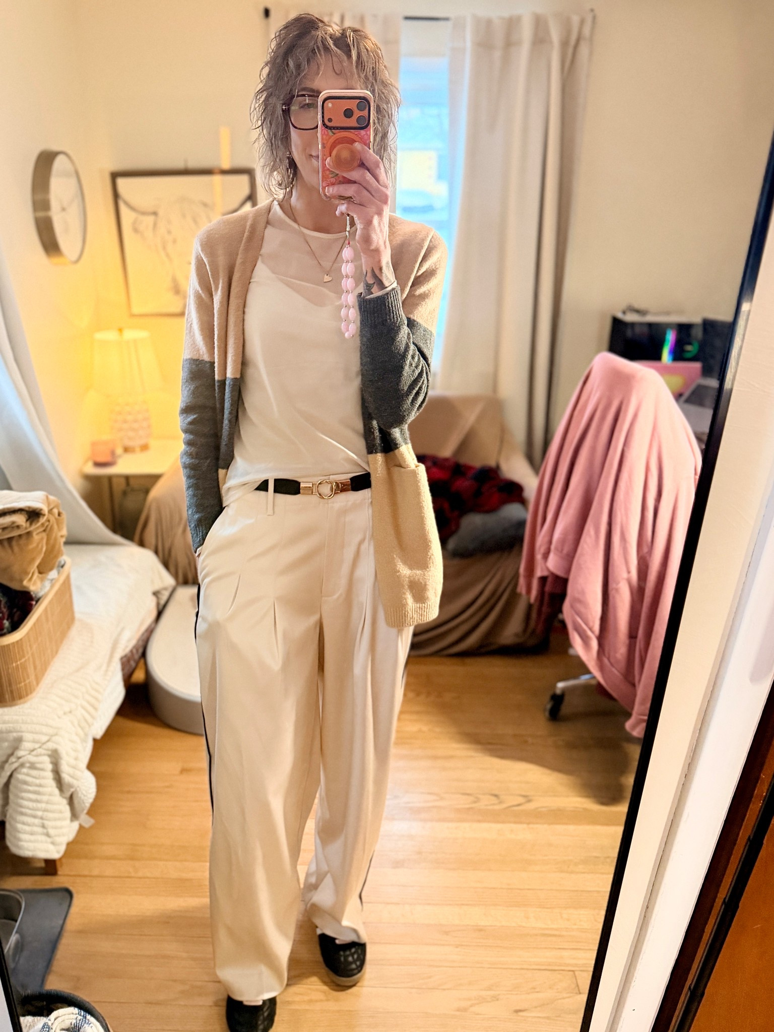 Wednesday’s #OOTD
Sneakers: Gola
Pants: Banana Republic Factory (size 8 Tall)
Sheer top: Gap
Cardigan: Nordstrom Rack (old)
Jewelry: Loft
These Banana Republic Factory trousers are one of those pieces that can swing dressy or casual depending on how you style them. I’m usually between a 6 and 8 and sized up to the 8 Tall for a looser, more relaxed fit. The fabric is super silky and drapey, with a thick, cream base and a black tuxedo stripe down the side.
I wore these to the office and they felt a little dressed up on their own, so I added sneakers to keep the look more casual. The sheer top adds just enough interest since the outfit is otherwise pretty modest and buttoned-up, and this casual tan-and-gray cardigan helps pull all the colors together.
Easy, comfortable, and very wearable.

#LTKTall #LTKOver40 #LTKootd