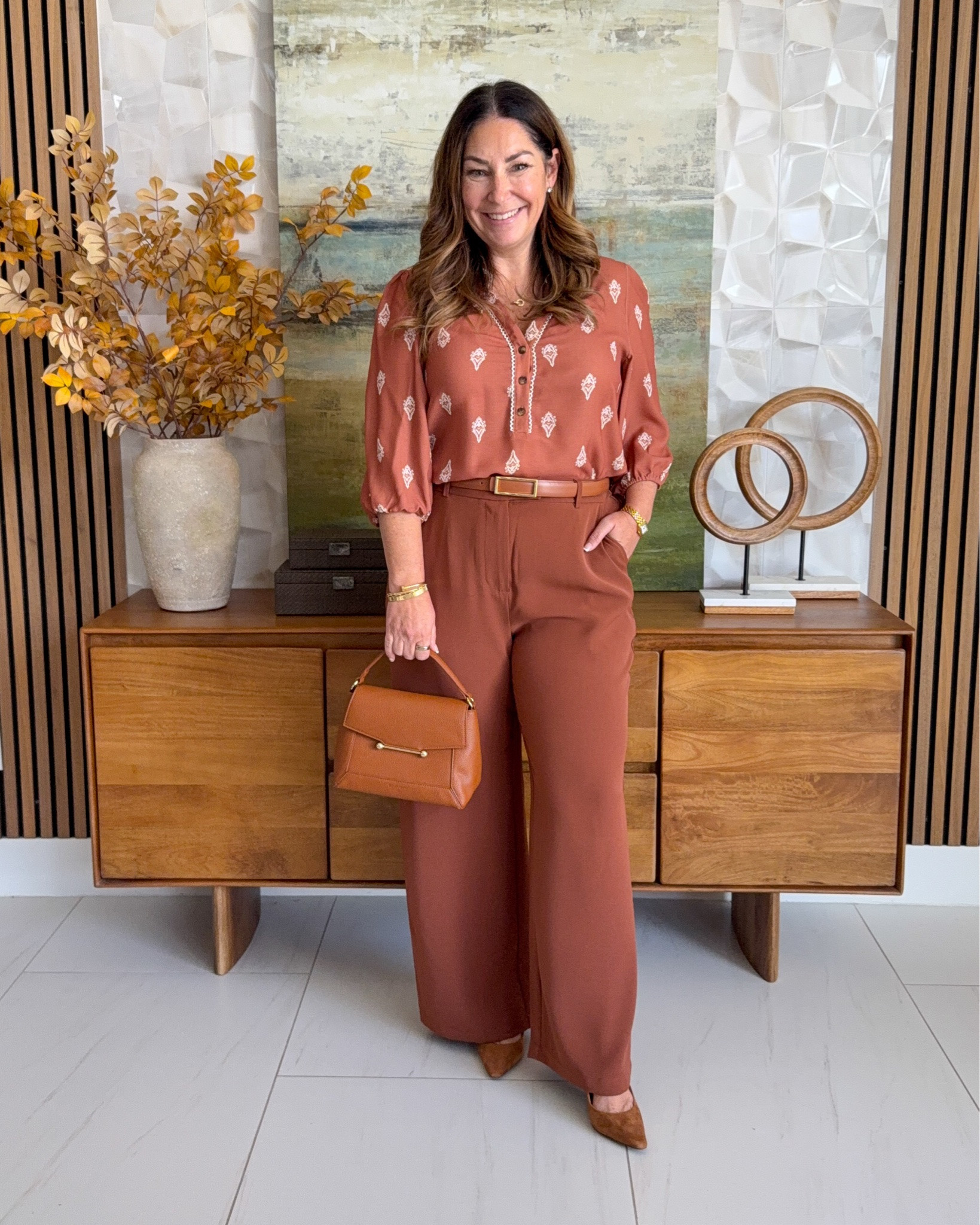 Tonal fall workwear outfit 🍂 Rust terracotta boho-print 3/4-sleeve blouse tucked into matching rust wide-leg trousers with a cognac belt, styled with a cognac top-handle bag and brown suede pumps. A monochromatic teacher outfit and business casual look in the prettiest fall color.

Sizing: Blouse tts, L | Pants tts, L

#LTKOver40