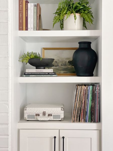 Built in shelf styling, black vase, black bowl, art, record player, fern, bookends, coffee table books

#LTKFind #LTKSale #LTKhome