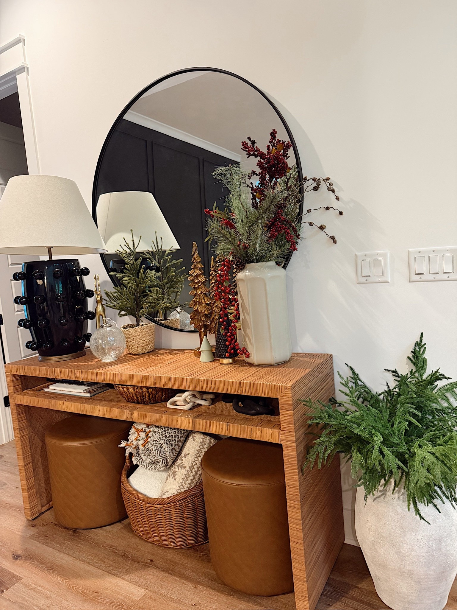 Entryway table Christmas styling! I love to do tall vases and seasonal sprigs to help tie this area into the Christmas vibes of the living room.

#LTKHome #LTKSeasonal #LTKHoliday