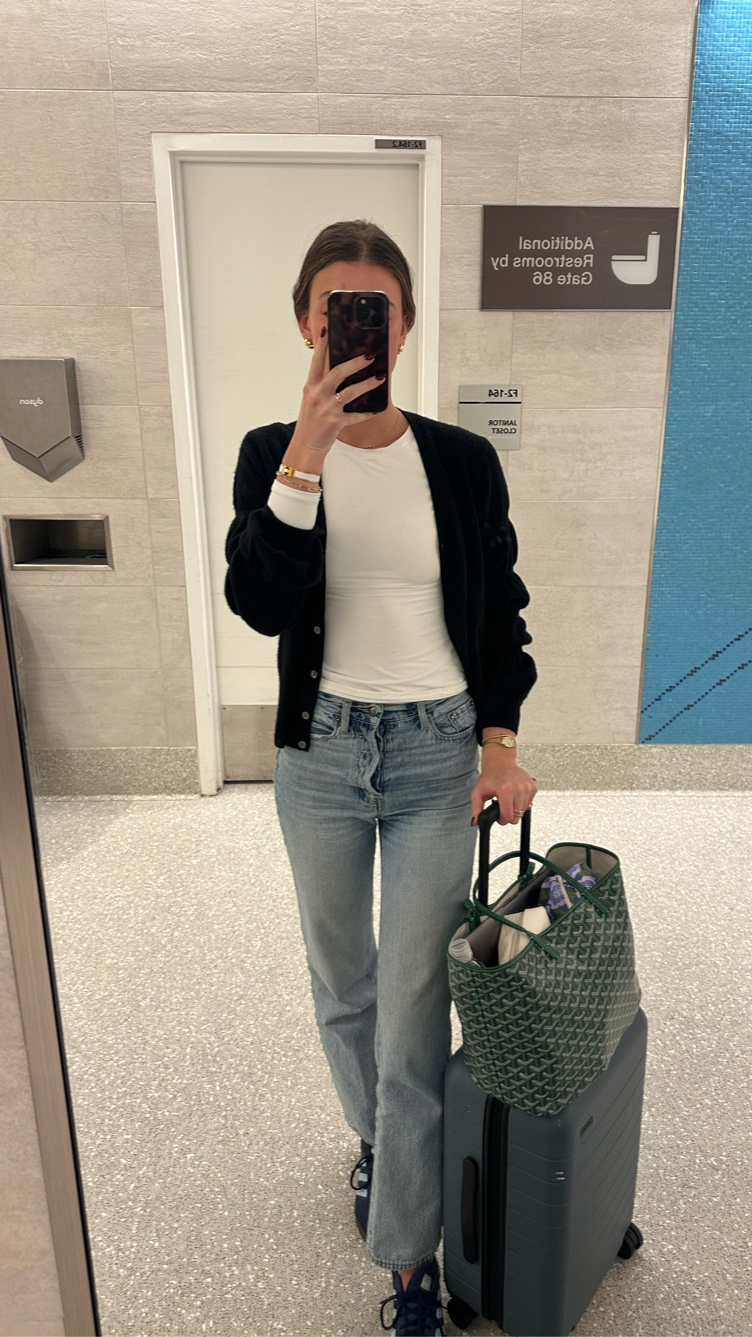 White long sleeve top with black cardigan sweater and light wash jeans. Gold jewelry. Away travel luggage. Travel outfit. Airport outfit. NYE outfit. Neutral outfit. Casual outfit. 

#LTKHoliday #LTKStyleTip #LTKTravel