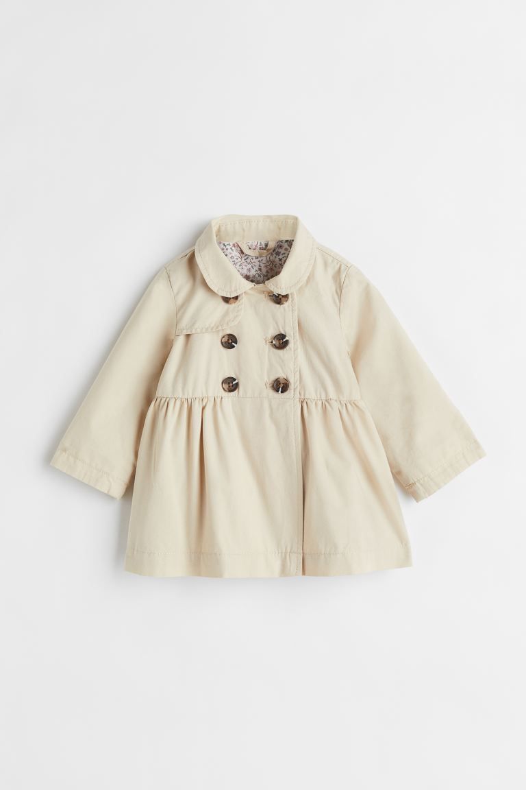 Double-breasted trenchcoat in woven cotton fabric. Rounded collar, attached yoke, and buttons at ... | H&M (US)