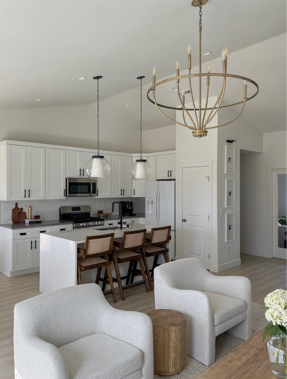 Living room accent arm chair, off white textured twill chairs. Walnut wood cane bar stools with arms. Kitchen pendants, 8 light chandelier, jute cotton mix rug. Wood coffee table large, accent side table 

#LTKhome #LTKSale #LTKsalealert