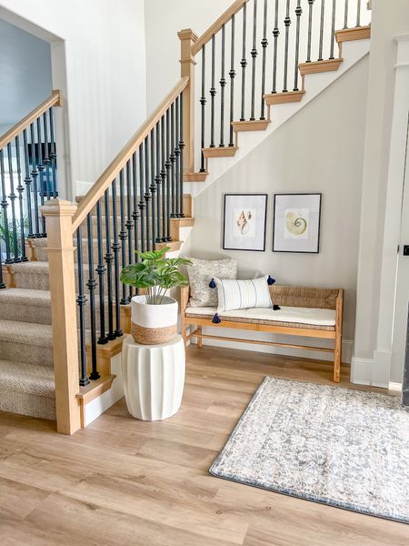 Welcoming front entry way with coastal them elements. Blue rug, rattan seagrass bench with cushion, blue throw pillows, modern lines cement garden stool for plants, black metal frame with white mats. 

Studio McGee, Threshold, Coastal

#LTKhome