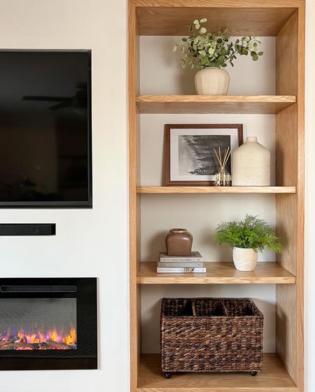 Living Room Built-In
Electric fireplace built-in. Faux greenery. Vase. Picture frame. Coffee table books. Large basket. Smart TV. Natural home. Contemporary home.

#LTKunder50 #LTKhome