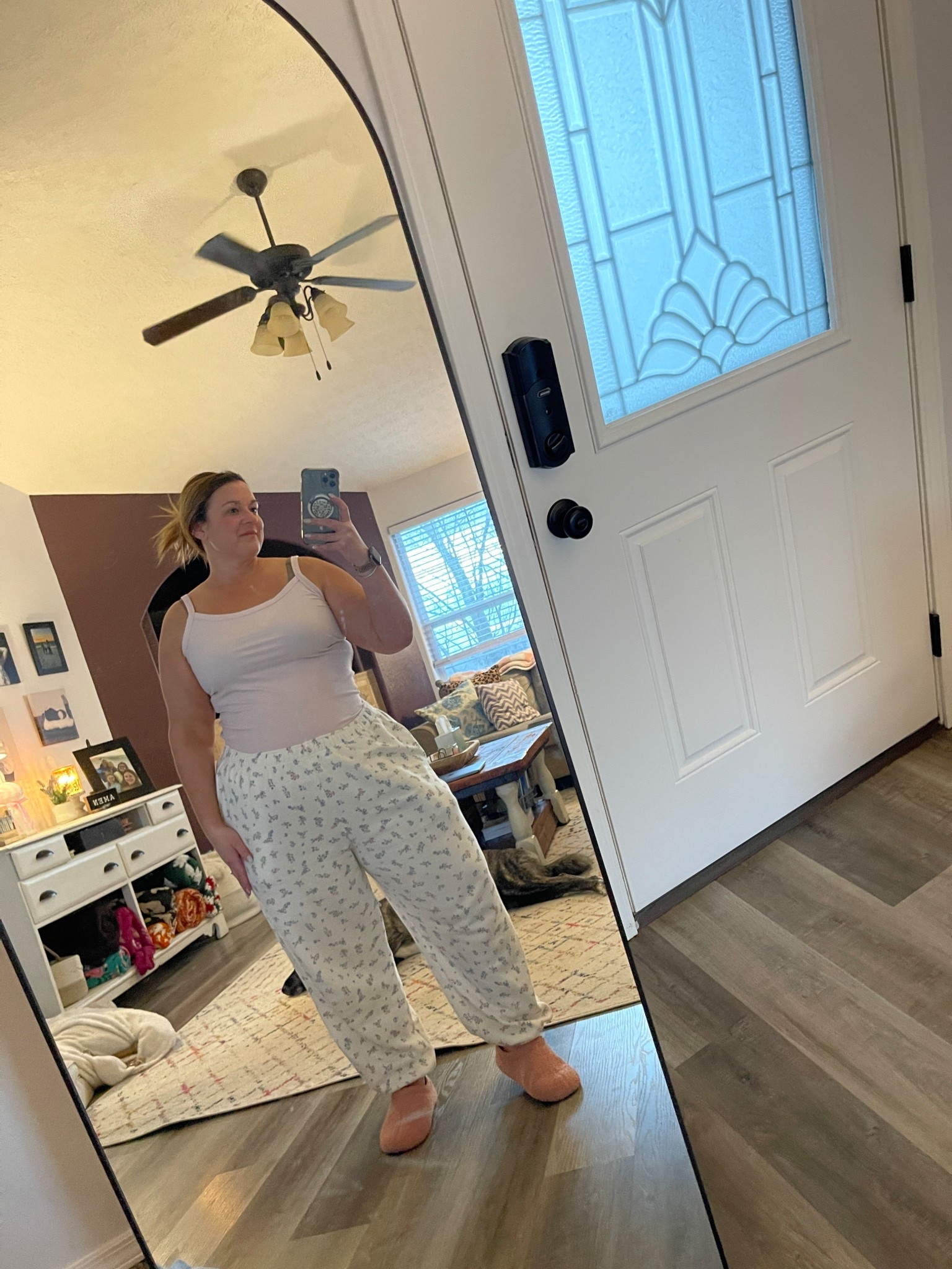 Spring OOTD for this 79° weather ☀️🌸 Loving this casual spring outfit — floral joggers, a pink ribbed tank top, and the coziest pink house shoes. This is the kind of comfy everyday outfit I live in during warm spring days.

If you’re looking for affordable spring outfits, comfy mom outfits, lounge outfits, or cute work from home outfits, this look is perfect. The floral joggers are lightweight and breathable, and a ribbed tank is a spring wardrobe staple you can style with everything.

Perfect for running errands, lounging at home, school pickup, or a casual spring day. Linking everything so you can shop this spring outfit on LTK.

#LTKmomlife #LTKSpringSale #LTKootd