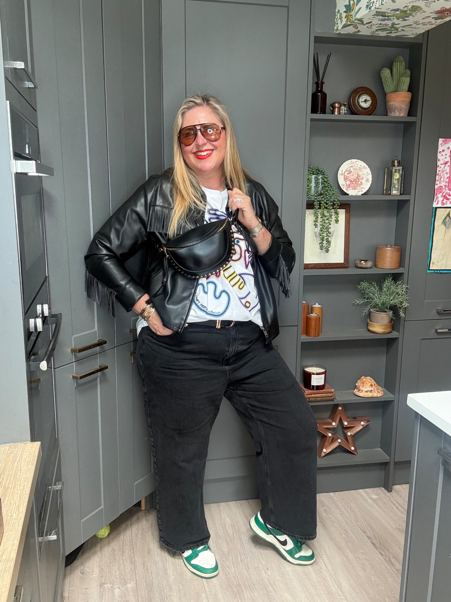 Tassel jacket, graphic tshirt, black jeans, green trainers, crossbody bag, sunglasses 

#LTKplussize #LTKjeans #LTKspring