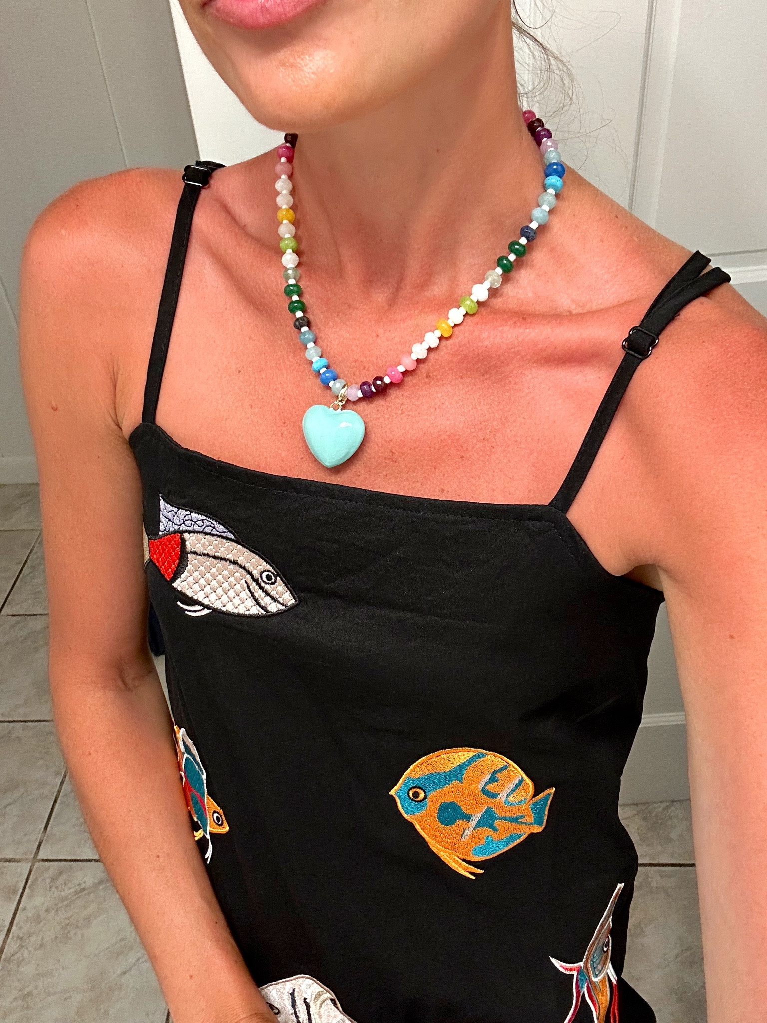 A fun little vacation dress with fish embellishments from Amazon along with the colorful beaded necklace with a heart pendant. Grab them both for under $60!