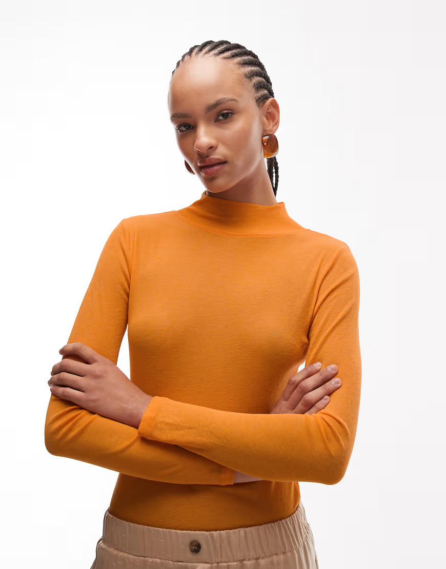 ASOS DESIGN – Figurbetontes Polohemd in Orange mit langen Ärmeln | ASOS (Global)