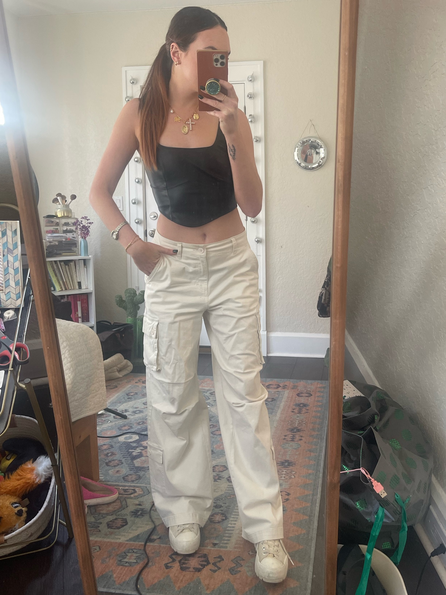 Black faux leather corset top with baggy white cargo pants and sneakers. Charm necklace and slicked back ponytail to finish the look 🤌🏽 perfect nighttime outfit for spring 🌸 

#LTKFindsUnder50 #LTKFindsUnder100 #LTKStyleTip