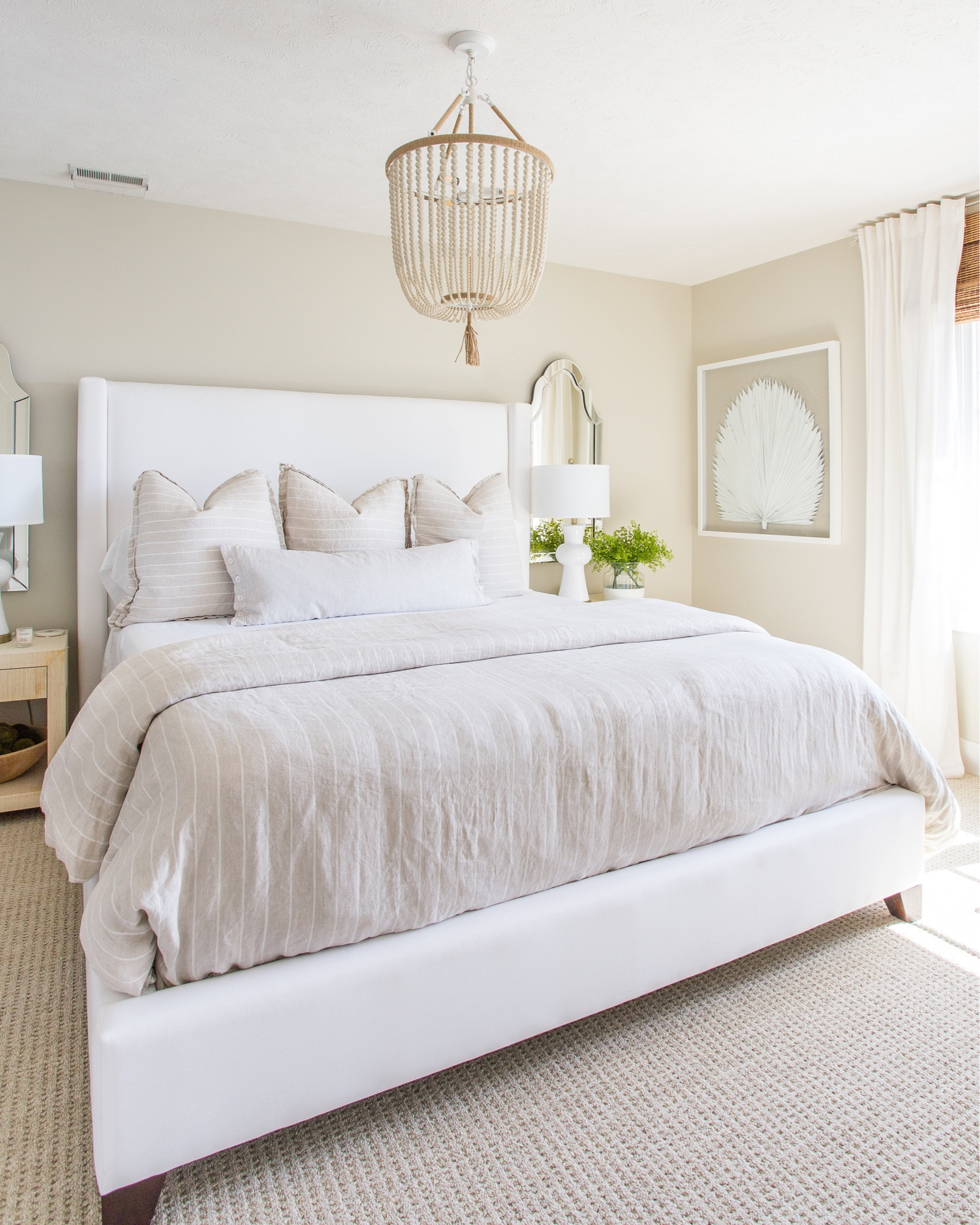 Our neutral guest bedroom includes a palm leaf shadow box art, an upholstered bed, a neutral striped duvet, linen striped euro shams and a wood beaded chandelier. Additional items include raffia nightstands, ceramic table lamps, a beveled frameless mirror, linen blackout curtains and bamboo roman shades.

simple decor, bedroom decor, fiddle leaf fig tree, bedroom lighting, bedroom mirror, guest bedroom inspiration, area rug, target chair, amazon home decor, master bedroom decor, pottery barn bed, pottery barn inspired room, coastal bedroom, bedroom bedding, abstract art, canvas wall art, classic design, simple decorating, target style, abstract wall art, bedroom rugs, guest bedroom décor, target home décor, amazon finds, serena and lily bedding, master bedroom, guest bedroom, bedroom decorating #ltkfamily 

#LTKSeasonal #LTKstyletip #LTKunder50 #LTKunder100 #LTKhome #LTKsalealert #LTKstyletip #LTKfamily #LTKhome