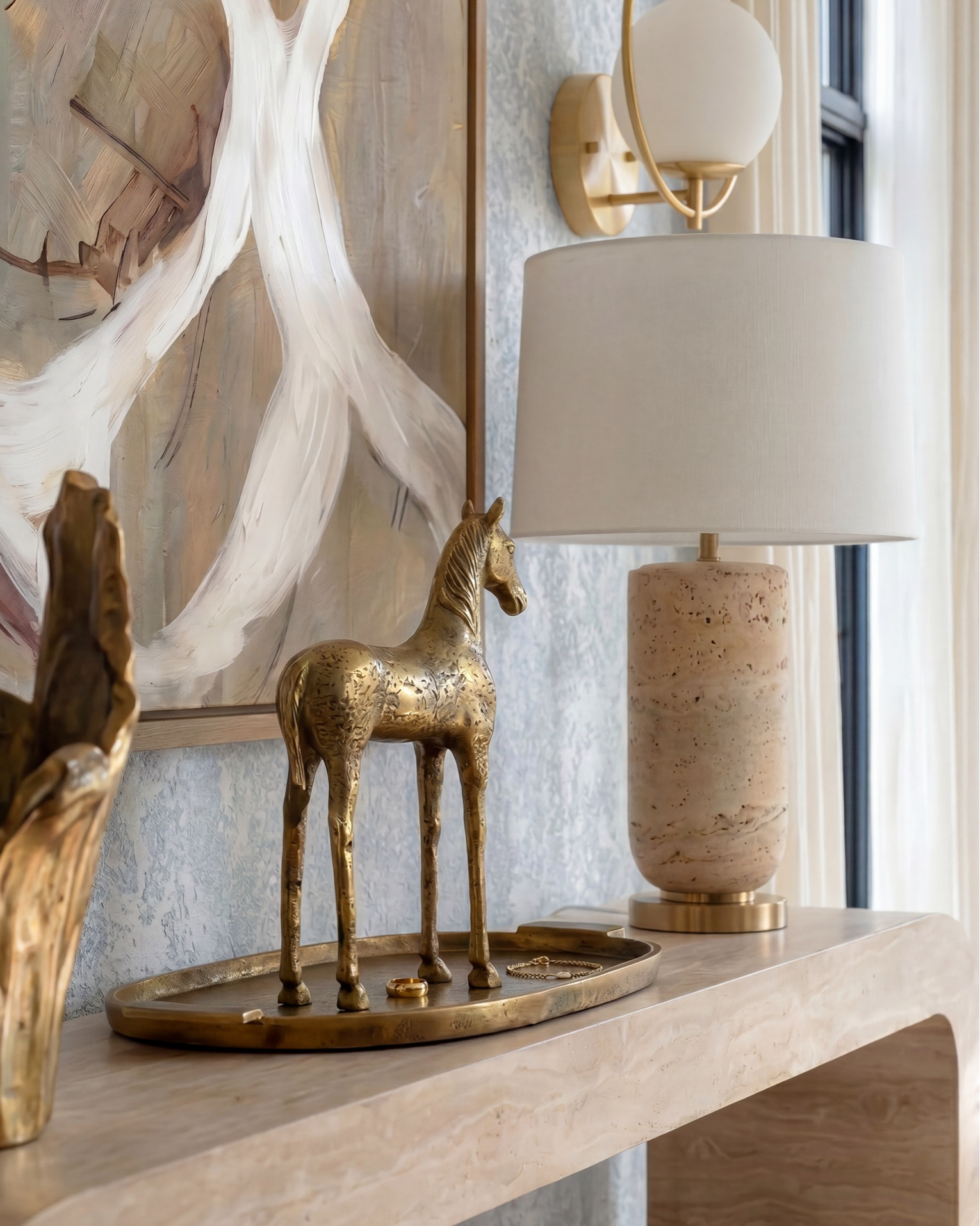 Shop the look:

* White upholstered accent chairs (modern box frame)
* Curved white sofa / loveseat
* Sculptural wood coffee table
* Organic wood side table stools
* Neutral textured area rug
* Marble fireplace surround (warm veining)
* Built-in glass display cabinets
* Light wood console table
* Upholstered round ottomans / stools
* Natural wood ceiling beams
* Light oak hardwood flooring
* Large white globe pendant light
* Fluted white glass pendant chandelier
* Brass wall sconces with globe shades
* Neutral ceramic table lamp
* Modern brass accent lighting
* Abstract neutral wall art
* Oversized framed artwork
* Gold sculptural decor objects
* Decorative brass tray
* Textured ceramic vase
* Organic sculptural vase centerpiece
* Decorative books for styling
* Neutral throw blanket
* Patterned accent pillow
* Small tabletop sculpture accents
* Textured runner rug
* Minimalist console styling
* Soft blue textured wallpaper
* Black framed windows
* Modern built-in shelving decor
* Layered neutral textiles

#LTKsale #LTKhome