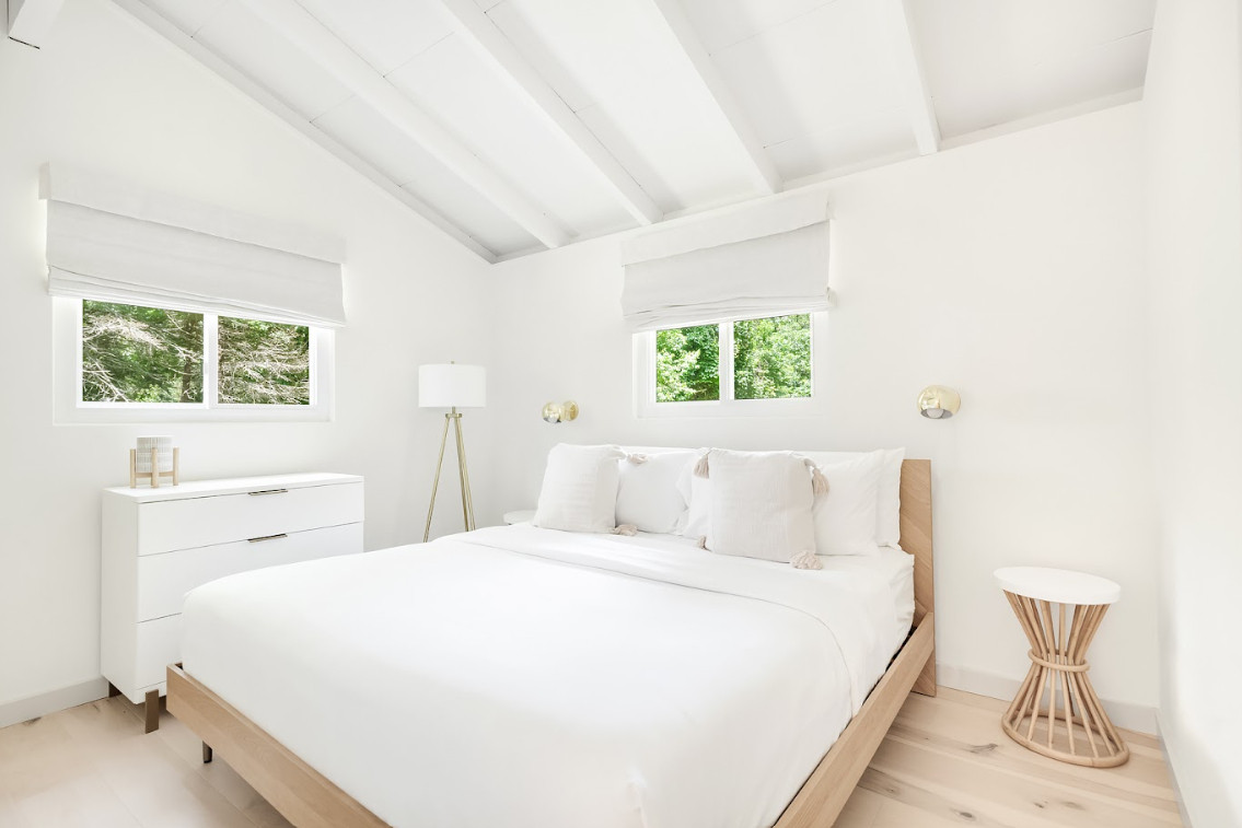 Wood bed frame, white bedding, and woven accents layered into a simple guest bedroom. We paired light wood floors, Roman shades, and a mix of warm wood and white finishes throughout the space. Linked the exact and similar pieces below.

#LTKHome #LTKSaleAlert