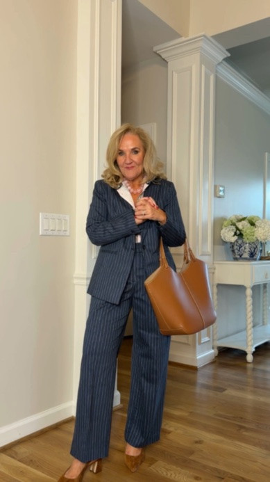 Tap the bell 🔔, heart ❤️ this post, and save for later!

This navy pinstripe suit is polished, flattering, and surprisingly easy to wear. Pair it with a simple blouse and cognac accessories for a timeless, pulled-together look.

Fit note: I'm wearing a size 6 Petite in the pants

#LTKootd #LTKWorkwear #LTKOver40