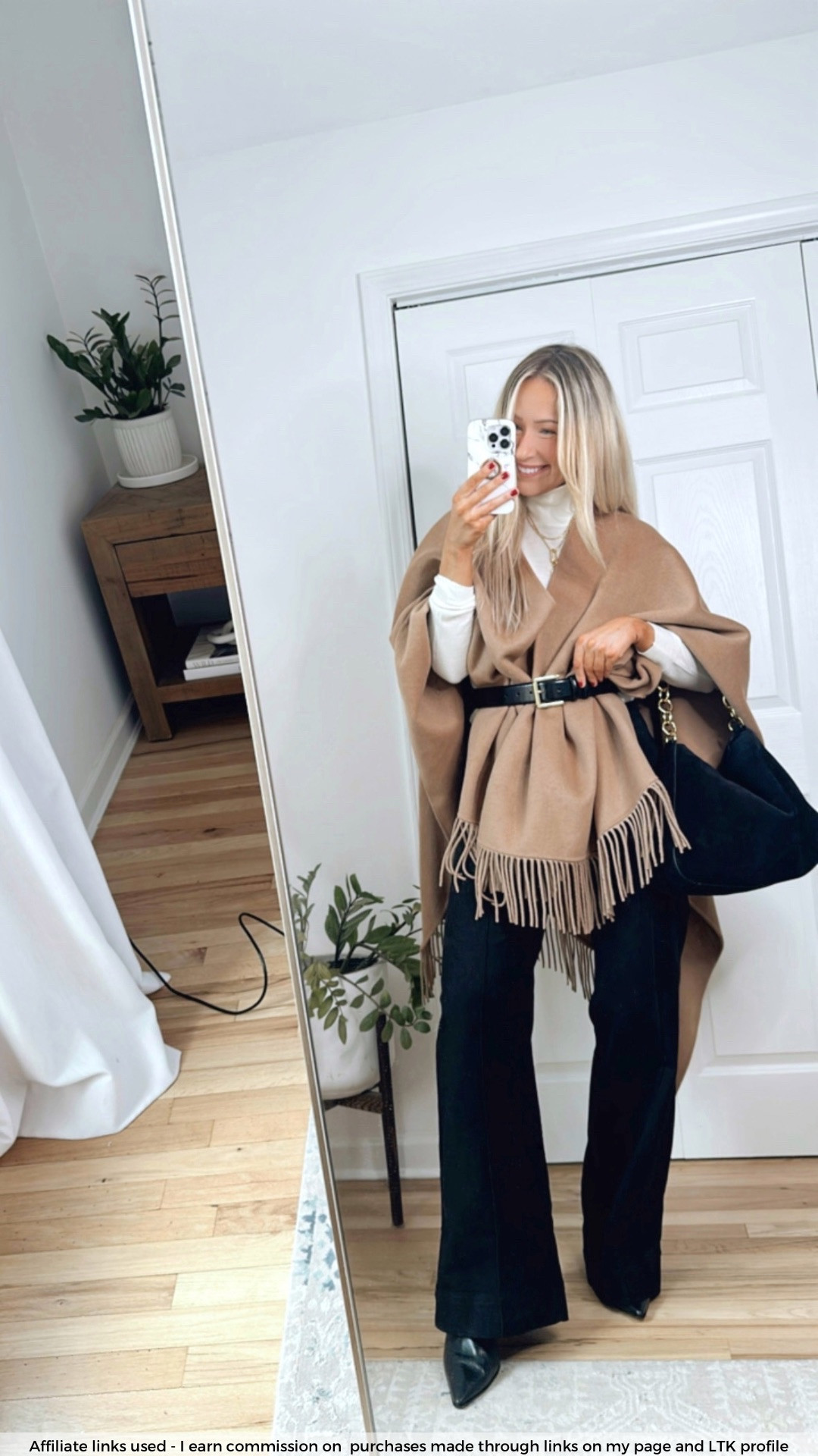 Zara wrap sweater cape with fringe details 

J.Crew jeans
Cream turtleneck sweater
Black suede bag
Black ankle boots 